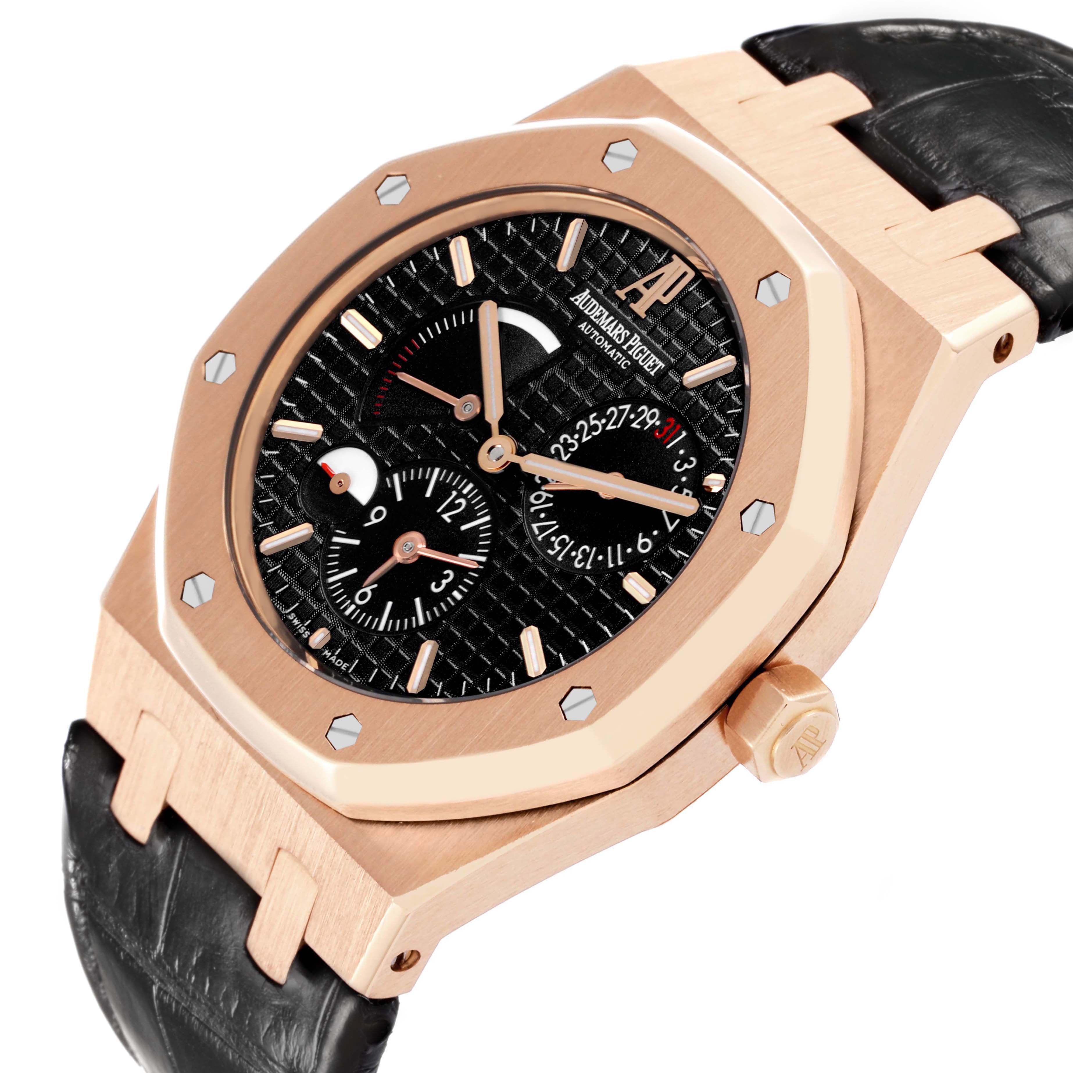 The Audemars Piguet Royal Oak 26120OR Men
s Rose Gold Black Dial watch is shown at an angle displaying the bezel, crown, dial with subdials, and part of the strap.