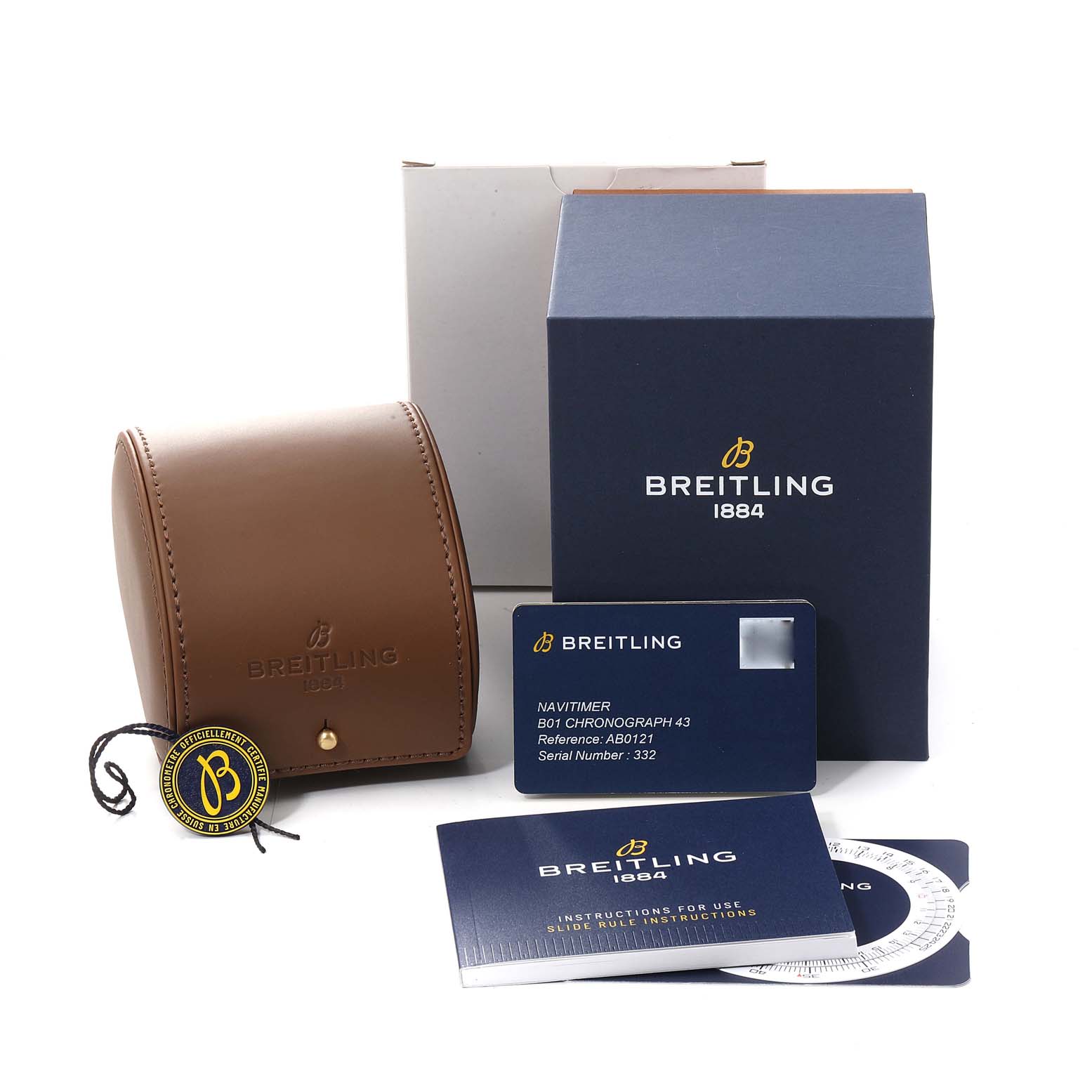 The image shows accessories for the Breitling Navitimer AB0121C4-C920-731P Men's Stainless Steel Blue Dial AB0121C4-C920-731P Men's Stainless Steel Blue Dial model, including a leather case, a box, a warranty card, and instruction manuals.