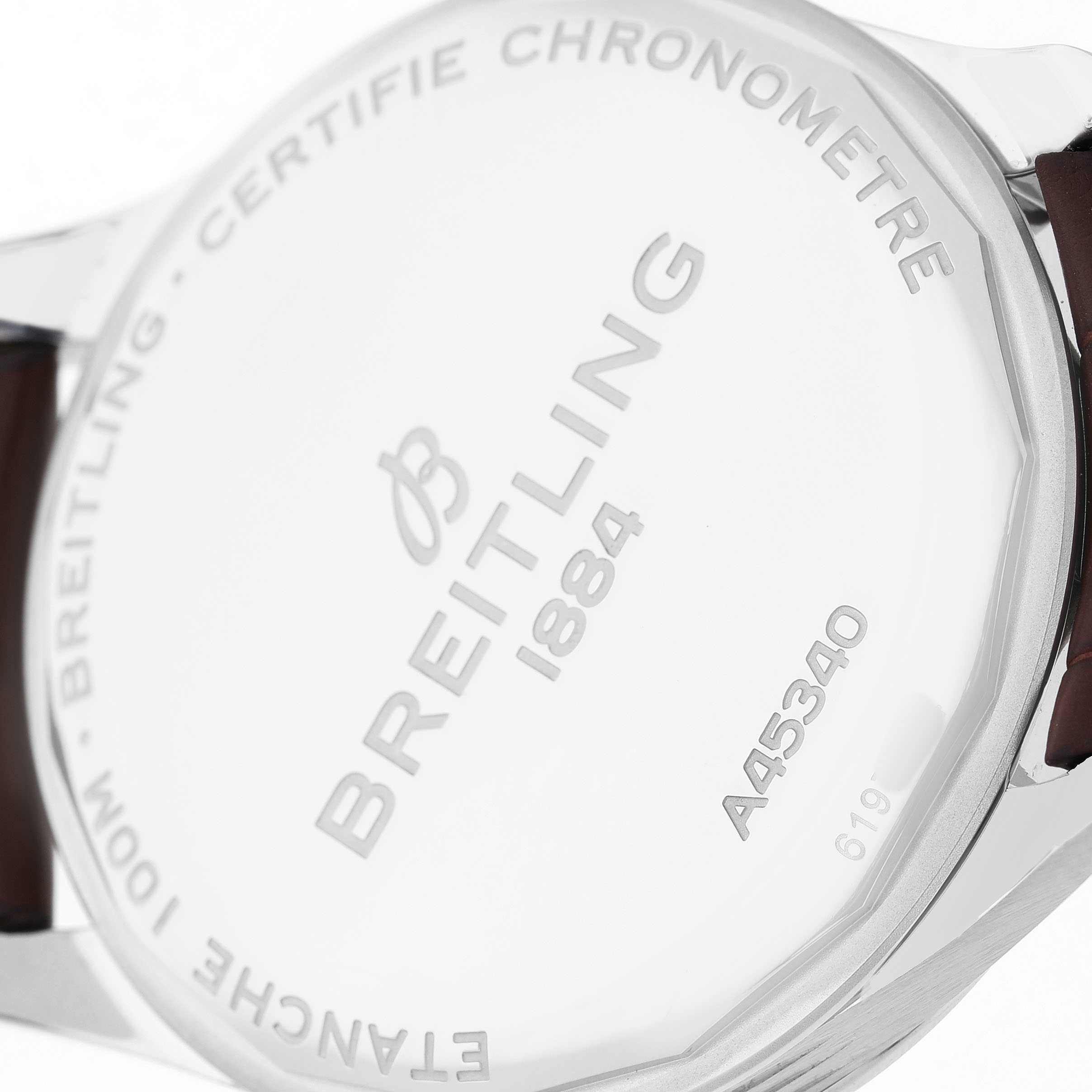 The image shows the back of a Breitling Premier A45340 Men's Stainless Steel Silver Dial watch, highlighting the engraved details and part of the strap.