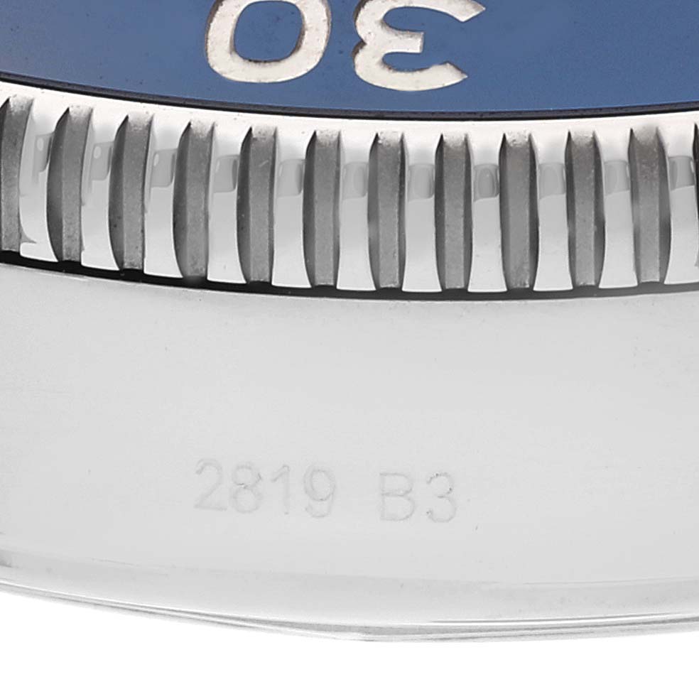This image shows a close-up of the Breitling Superocean A13313 Men's Stainless Steel Blue Dial A13313 Men's Stainless Steel Blue Dial's bezel and part of the case, with visible markings.