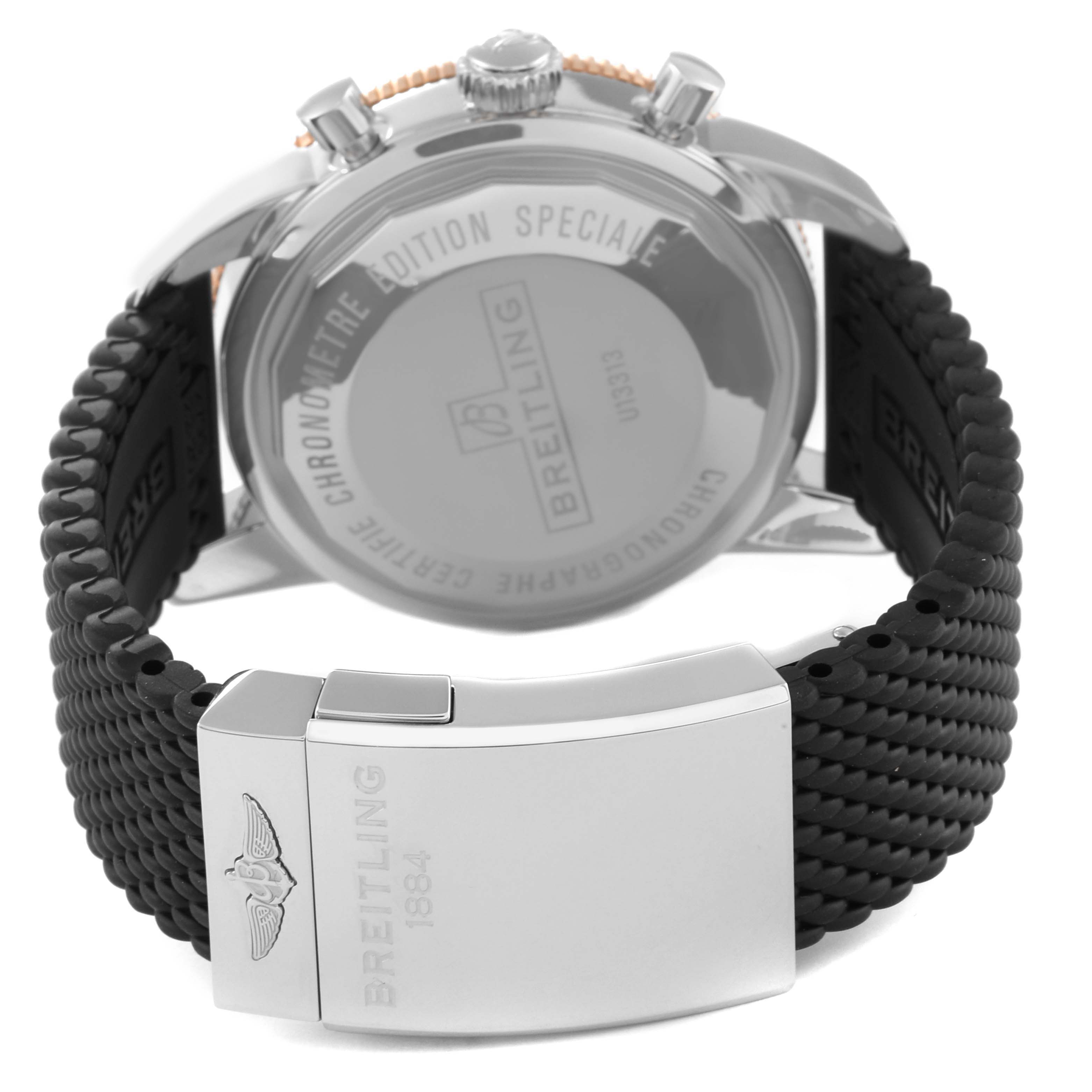 The image shows the back of the Breitling Superocean U1331312/BG50/279S/A20D.4 Men's Steel and Gold (two tone) Black Dial U1331312/BG50/279S/A20D.4 Men's Steel and Gold (two tone) Black Dial watch with a focus on its clasp and the woven strap.