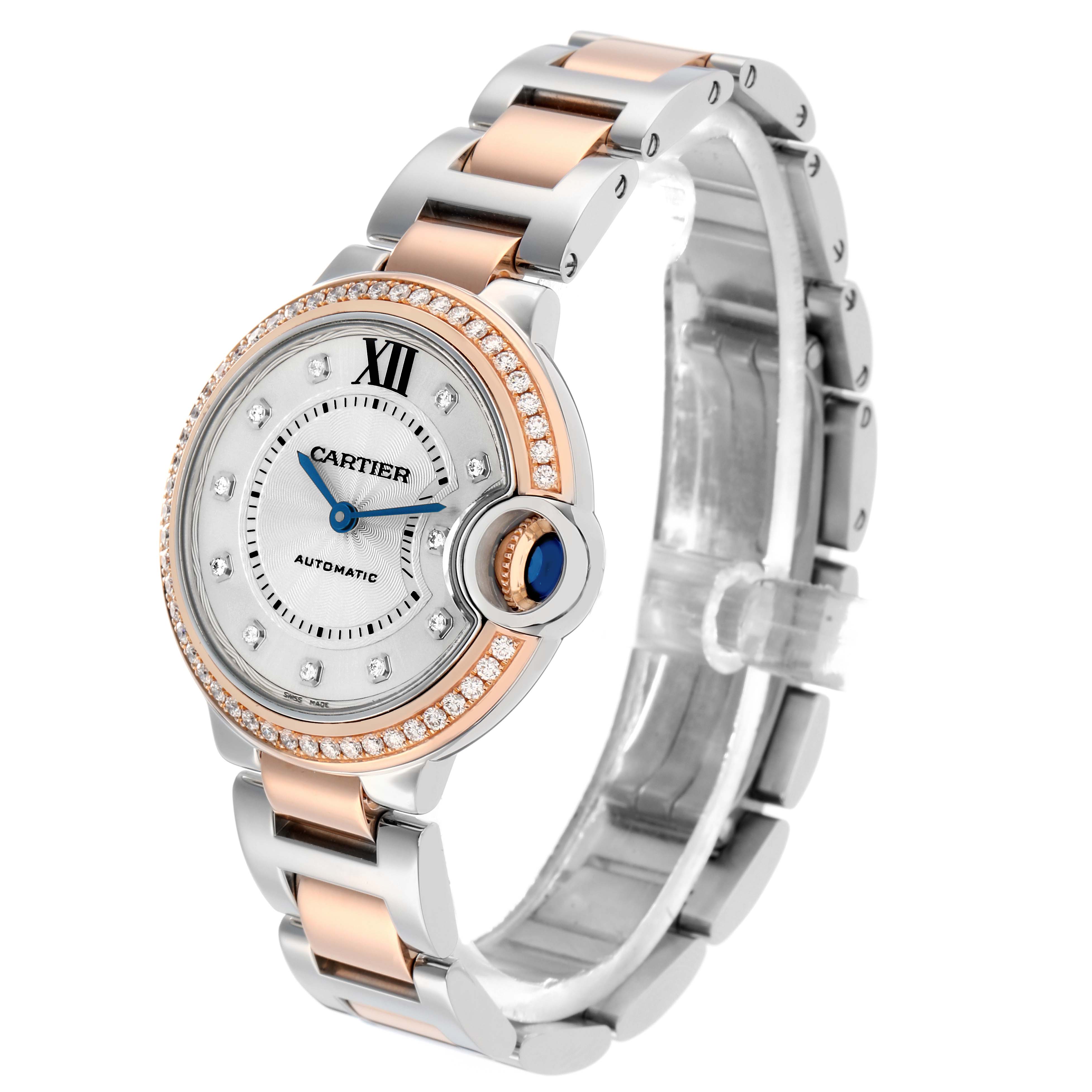 The Cartier Ballon Bleu WE902077 Women's Steel and Gold (two tone) Silver Dial watch is shown at a three-quarter angle, highlighting its dial, diamond bezel, and two-tone bracelet.
