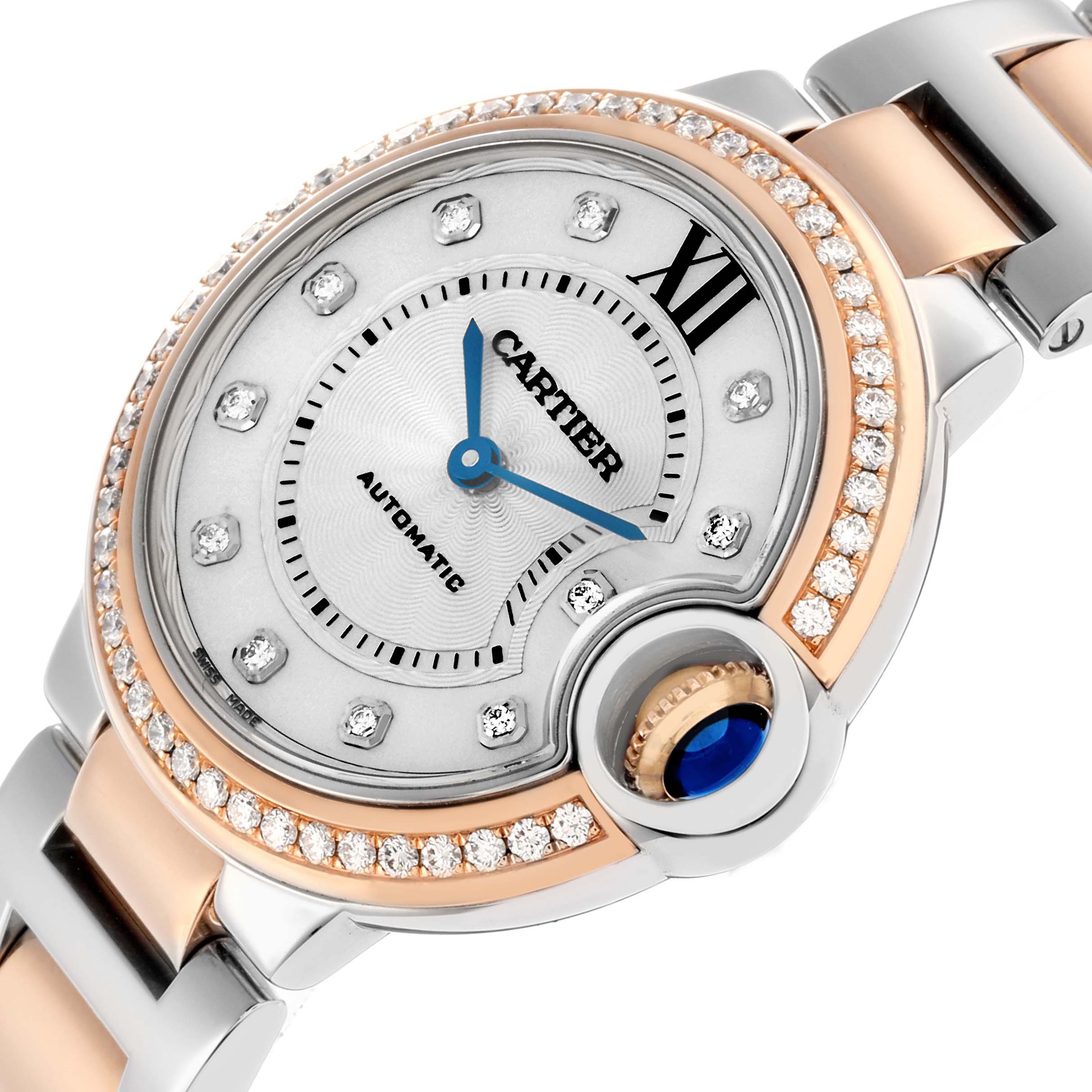 The Cartier Ballon Bleu WE902077 Women's Steel and Gold (two tone) Silver Dial watch is shown at an angled view, highlighting its diamond bezel, Roman numeral detail, and blue cabochon crown.