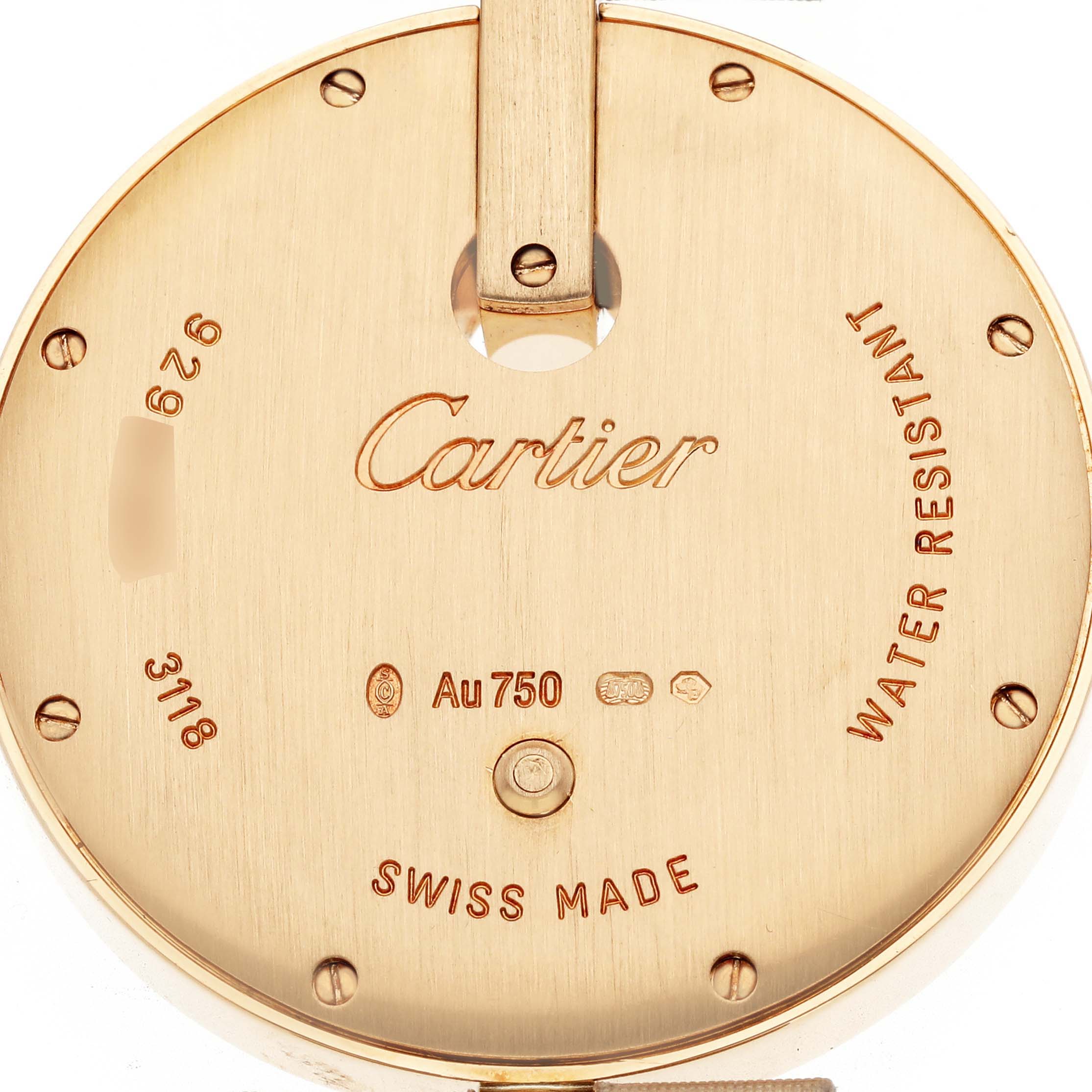 The image shows the back case of a Cartier Ballon Bleu WG600010 Women's Yellow Gold Silver Dial watch, displaying inscriptions and hallmarks.