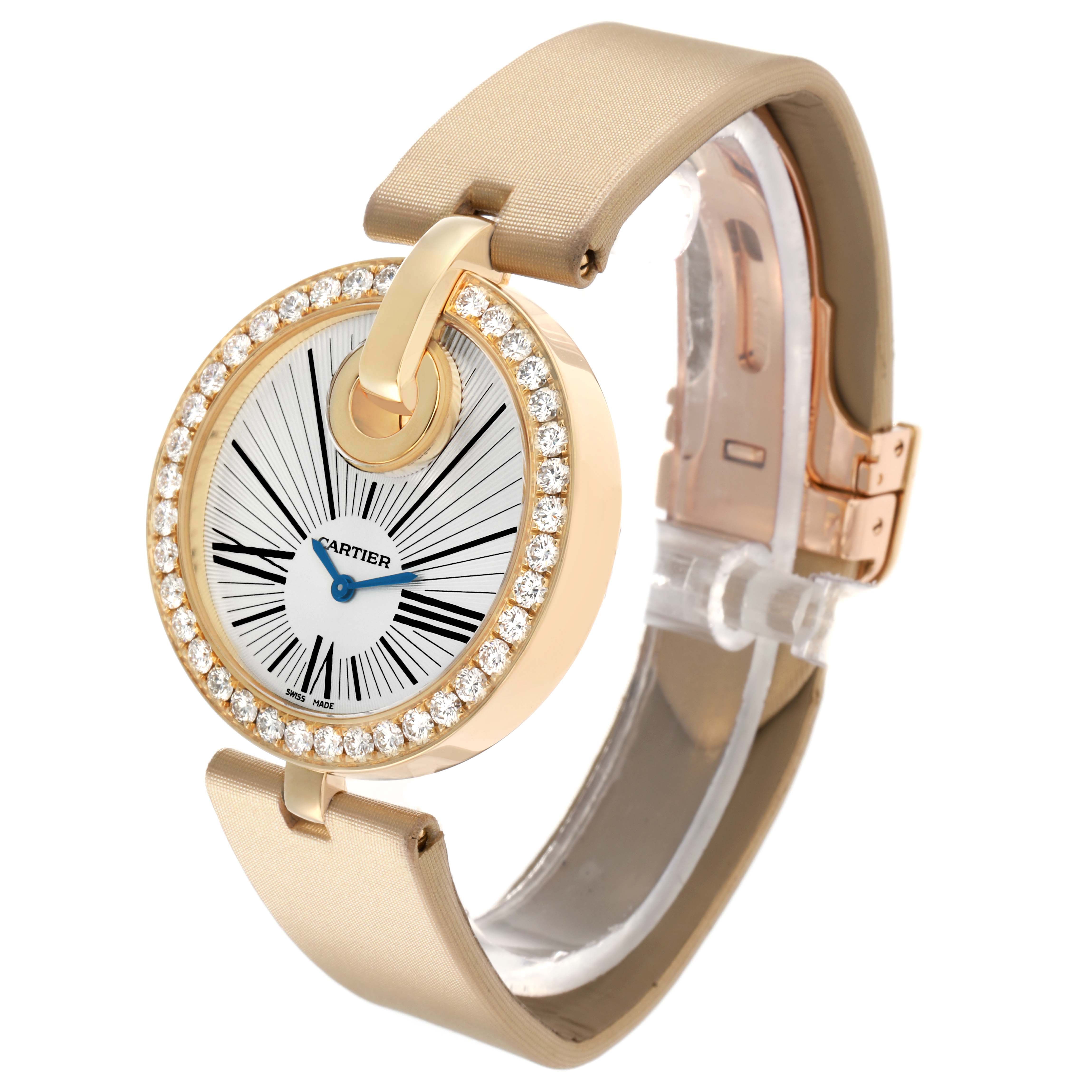 The Cartier Ballon Bleu WG600010 Women's Yellow Gold Silver Dial watch is shown in a side angle, highlighting the diamond-studded bezel and beige strap.