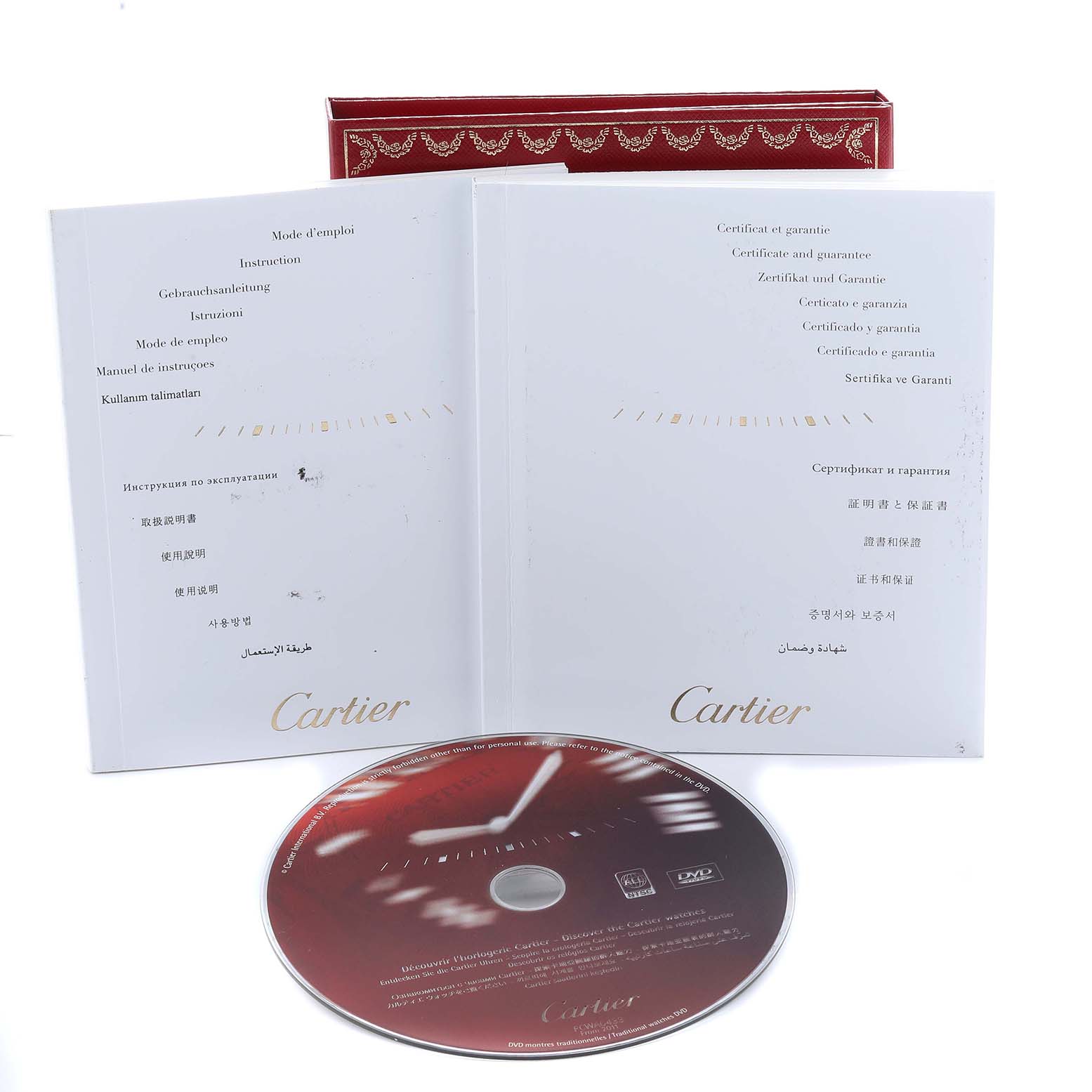 The image shows instruction manuals and a warranty certificate alongside a DVD for the Cartier Ballon Bleu WG600010 Women's Yellow Gold Silver Dial watch.