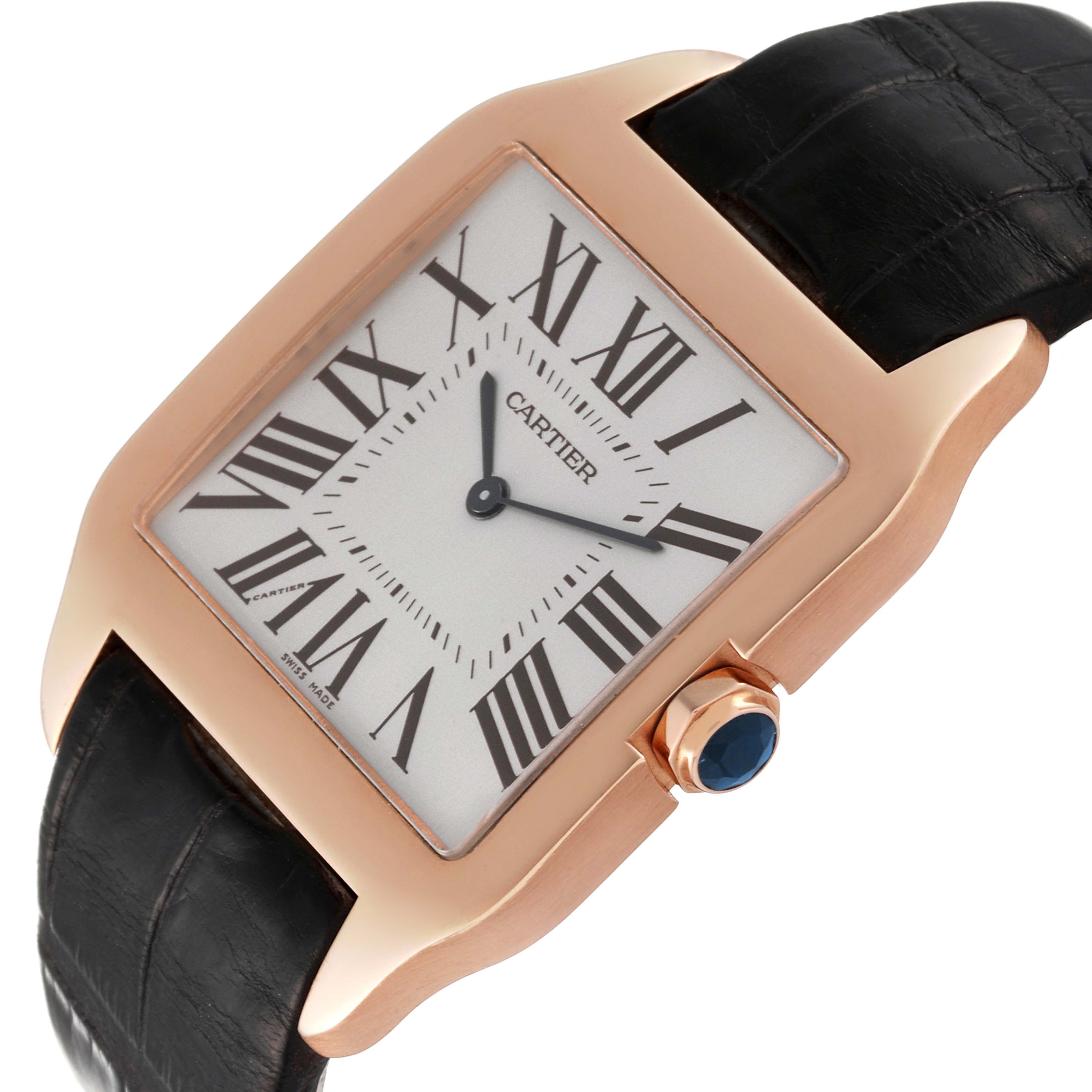 This image shows a close-up of the Cartier Santos Dumont W2006951 Men's Rose Gold Silver Dial W2006951 Men's Rose Gold Silver Dial watch, highlighting its face, Roman numeral markers, and black leather strap.