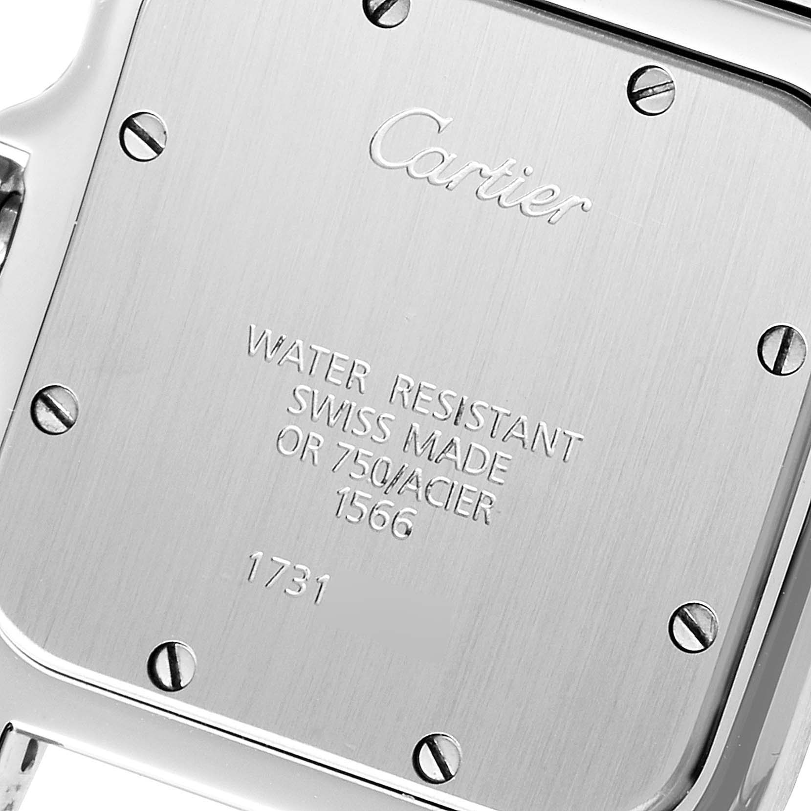This image shows the back case of a Santos model watch by Cartier, featuring engraved details and screws.