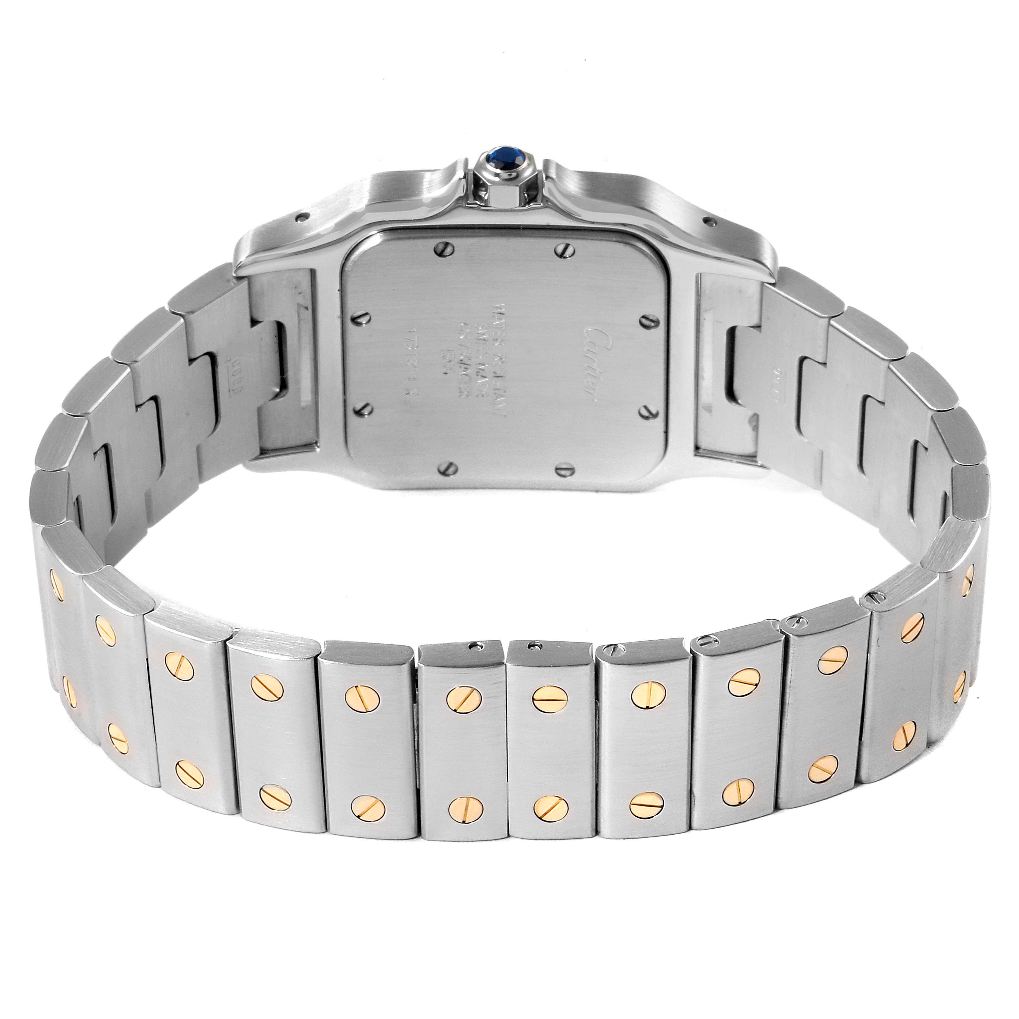 The image shows the backside and bracelet of a Santos de Cartier watch, emphasizing the stainless steel band with gold screws.