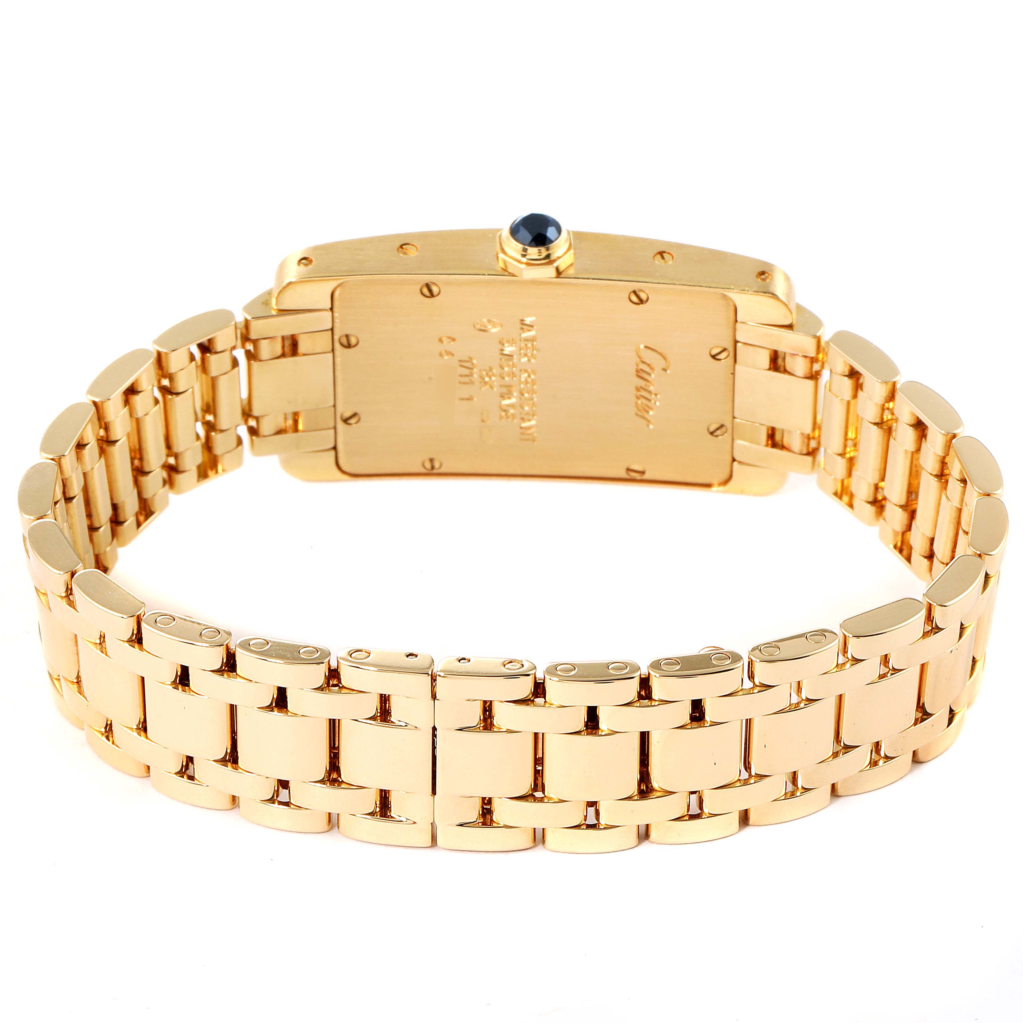 The image shows the back of a Cartier Tank Americaine W26015K2 Women's Yellow Gold Silver Dial W26015K2 Women's Yellow Gold Silver Dial watch, highlighting its gold bracelet and case back.