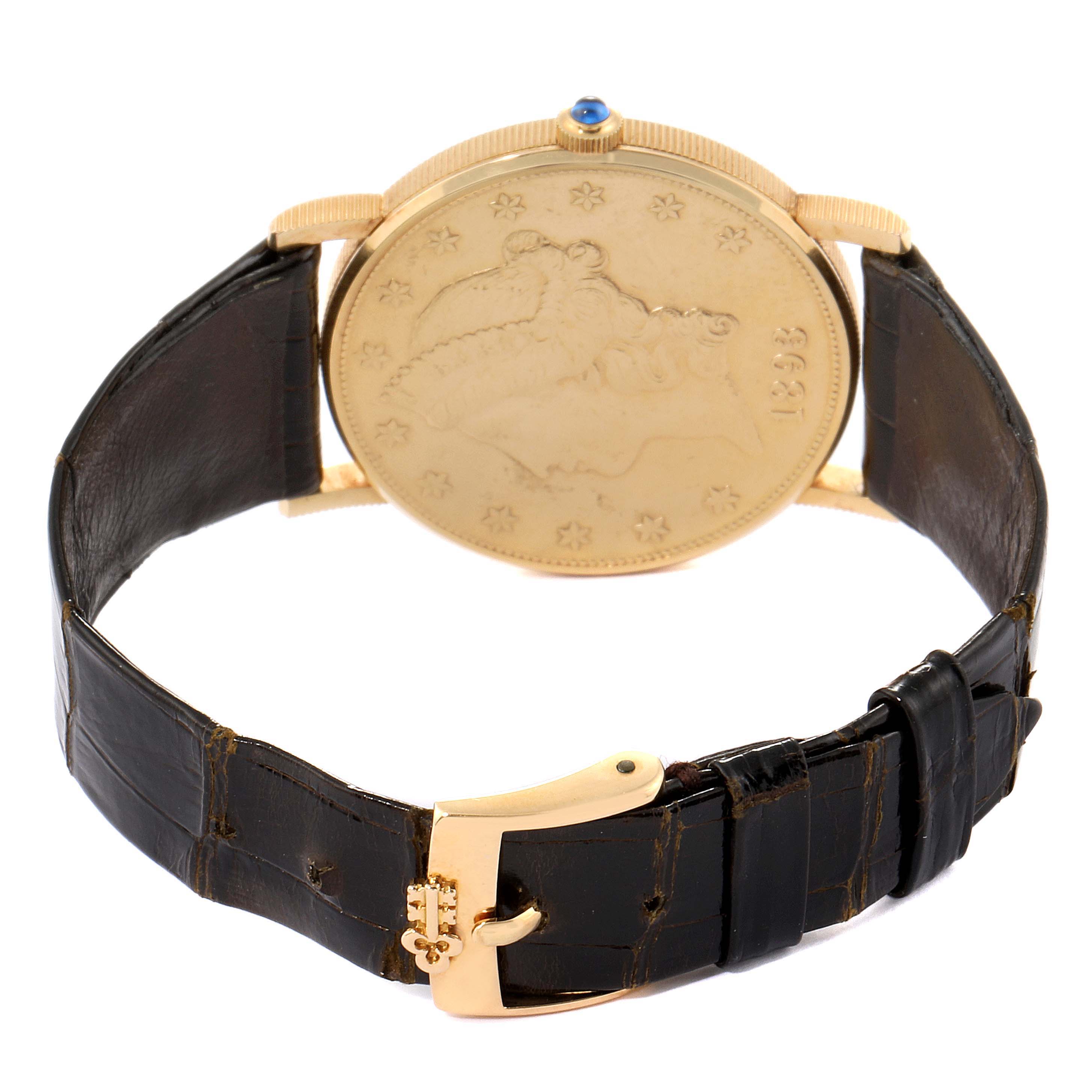 The image shows the back and strap of a Corum Coin Watch  Men's Yellow Gold Black Dial  Men's Yellow Gold Black Dial model, highlighting its gold casing and black leather strap.