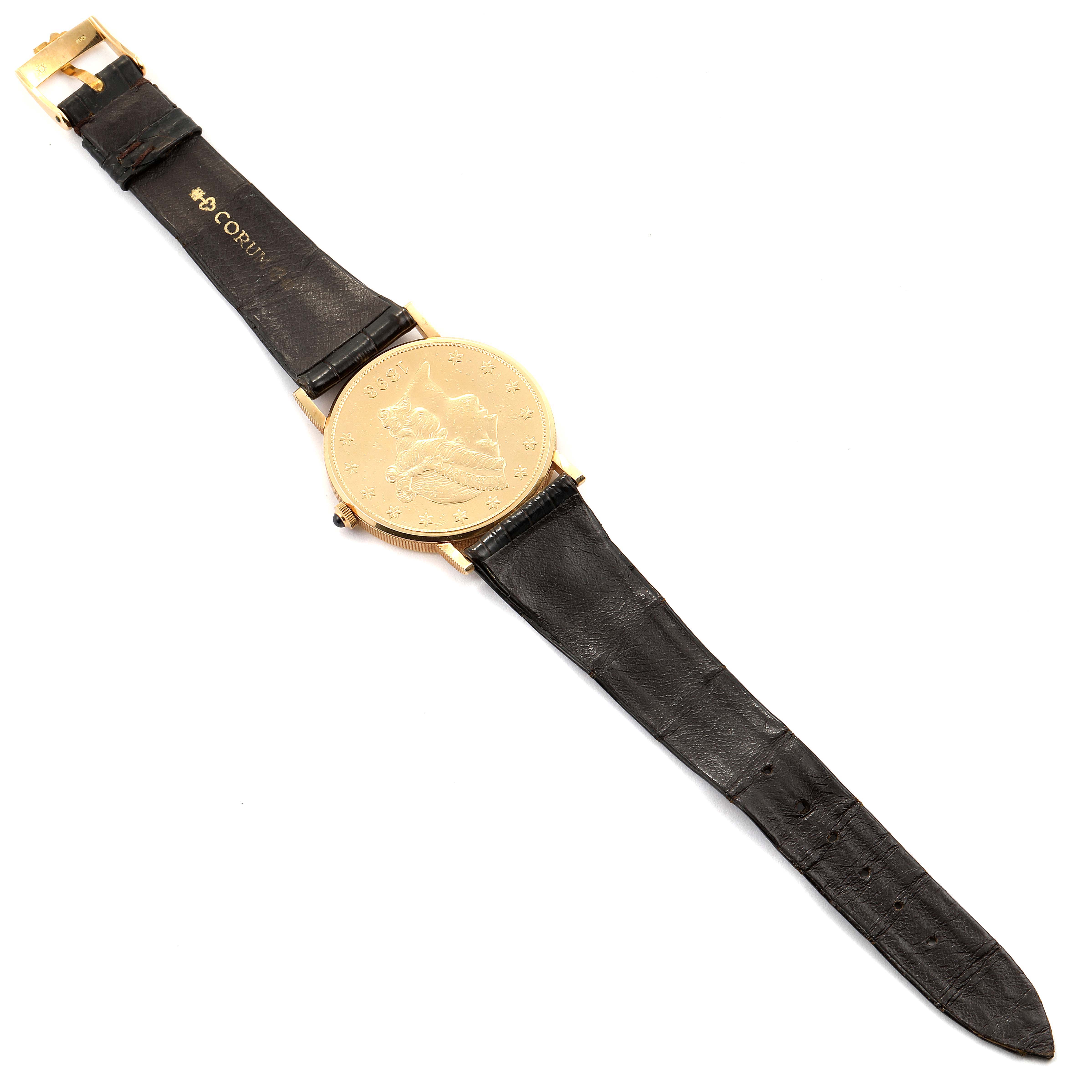 The Coin Watch model by Corum is shown from a top-down angle, displaying the entire watch and strap.