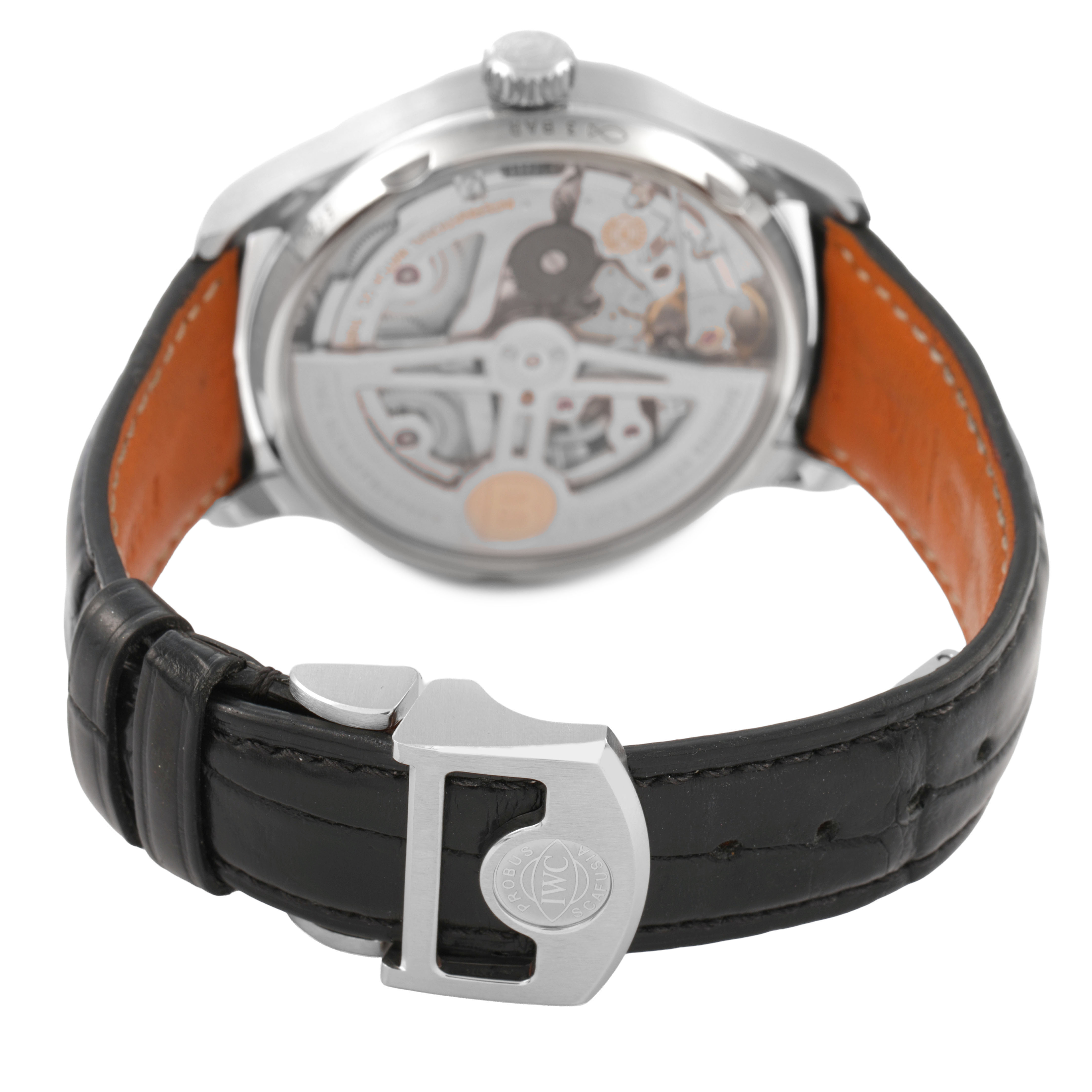 The image shows the back view of an IWC Portuguese IW500708 Men's Stainless Steel Green Dial watch, highlighting the movement and black leather strap with a clasp.