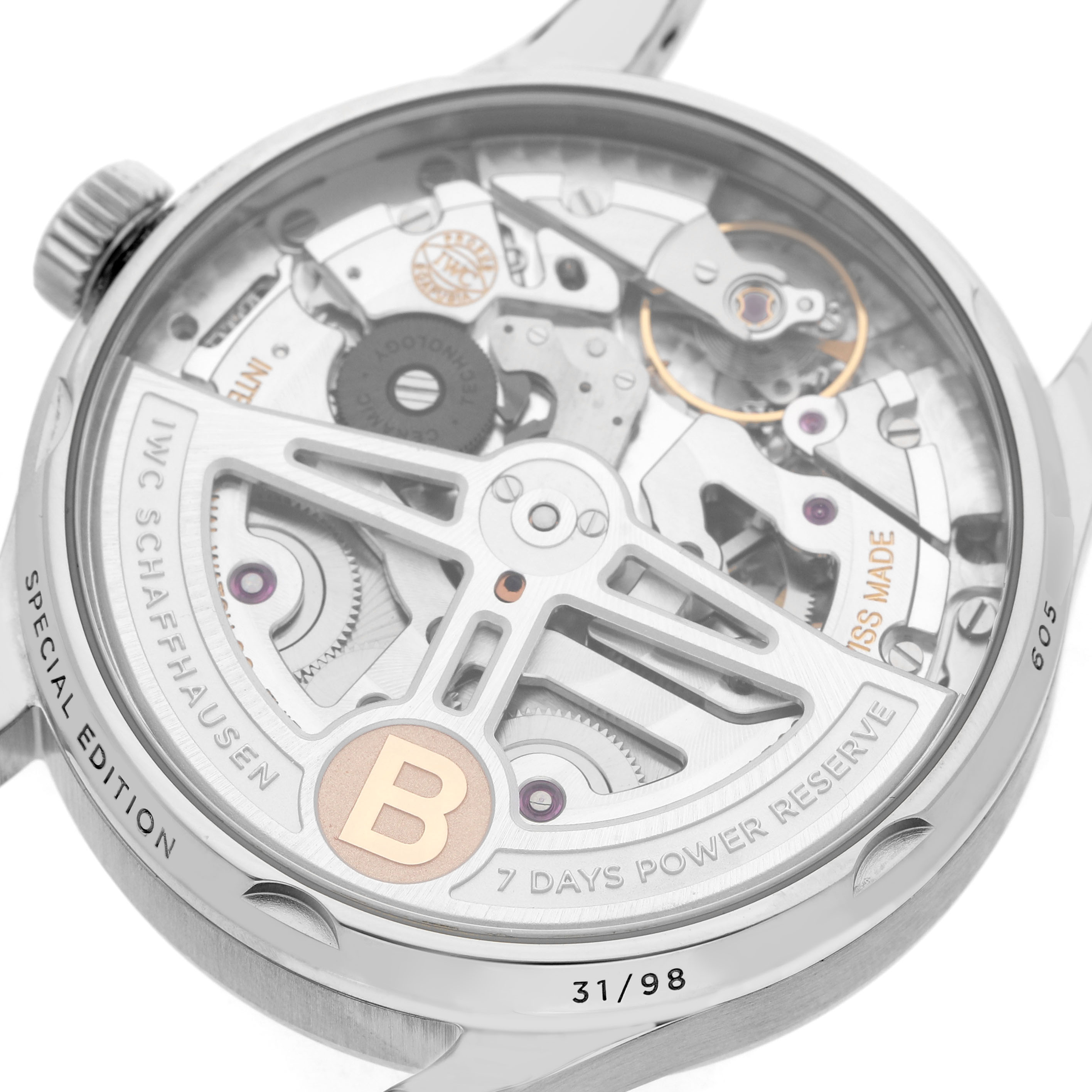 The image shows the back view of an IWC Portuguese IW500708 Men's Stainless Steel Green Dial watch, highlighting its intricate movement and power reserve indicator.