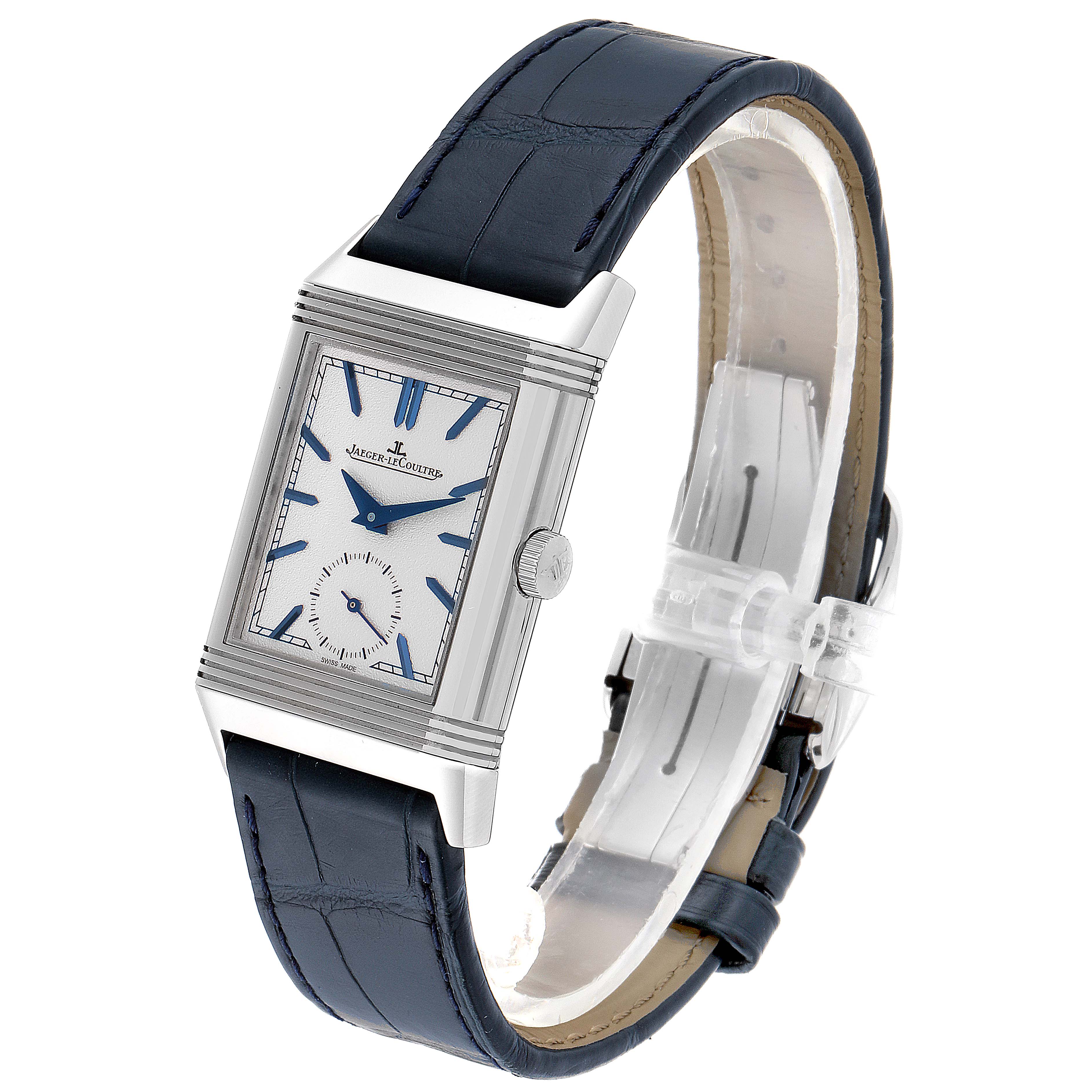 The Jaeger-LeCoultre Reverso watch is shown at a slight angle, highlighting its rectangular face and blue leather strap.
