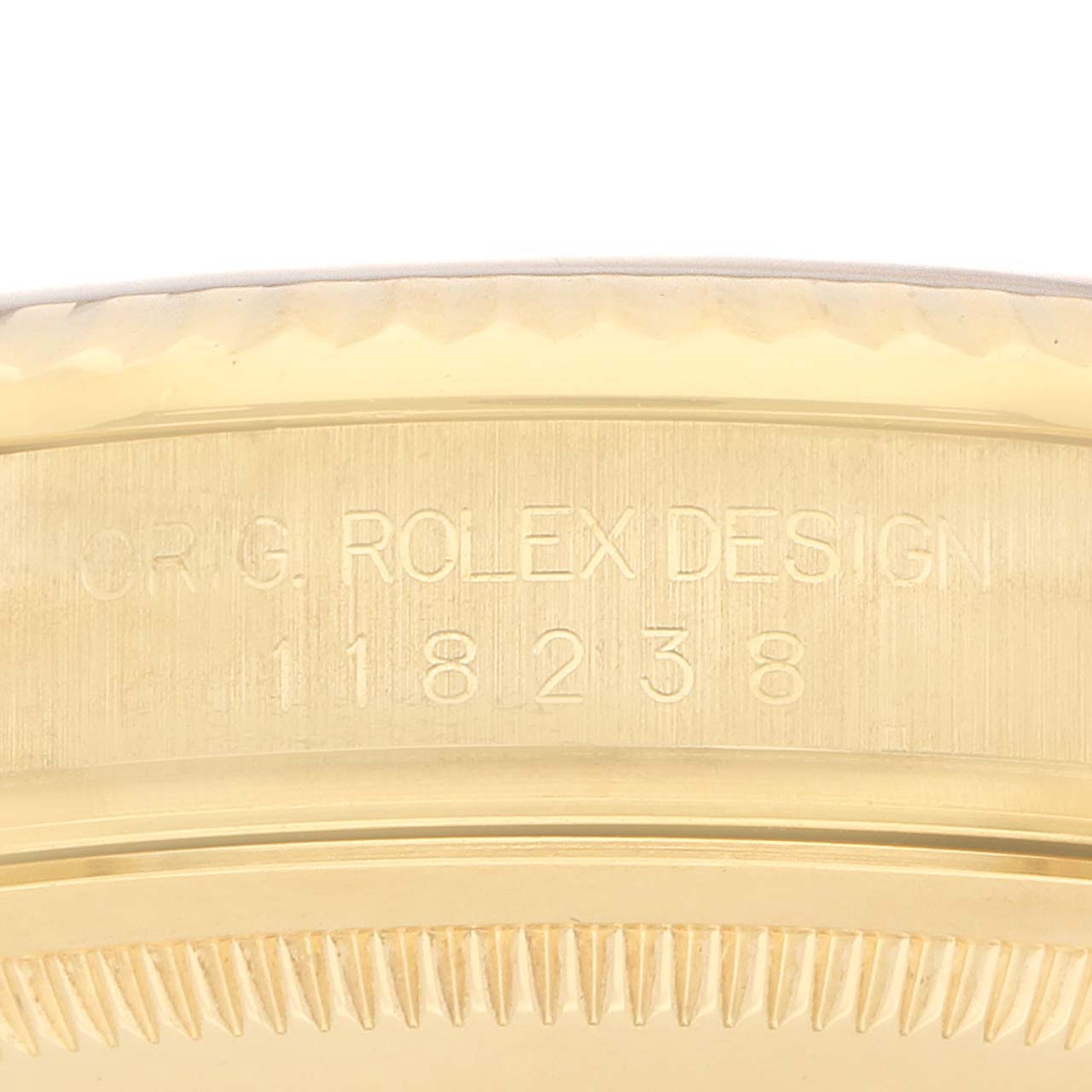 This image shows a close-up of the side of a Rolex President 118238 Men's Yellow Gold Champagne Dial model, highlighting the engraved design number.