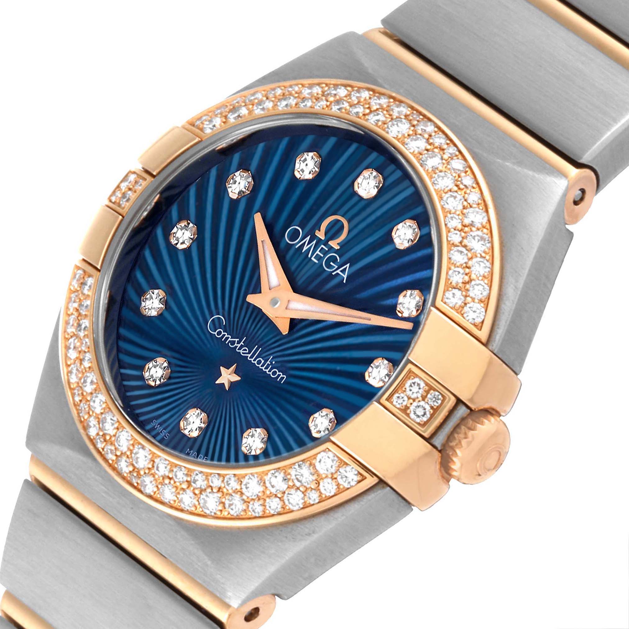 This image shows a close-up of the face and bezel of the Omega 123.25.24.60.53.001 Women's Steel and Gold (two tone) Blue Dial 123.25.24.60.53.001 Women's Steel and Gold (two tone) Blue Dial Constellation Steel Rose Gold Diamond Ladies Watch model 123.25.24.60.53.001.