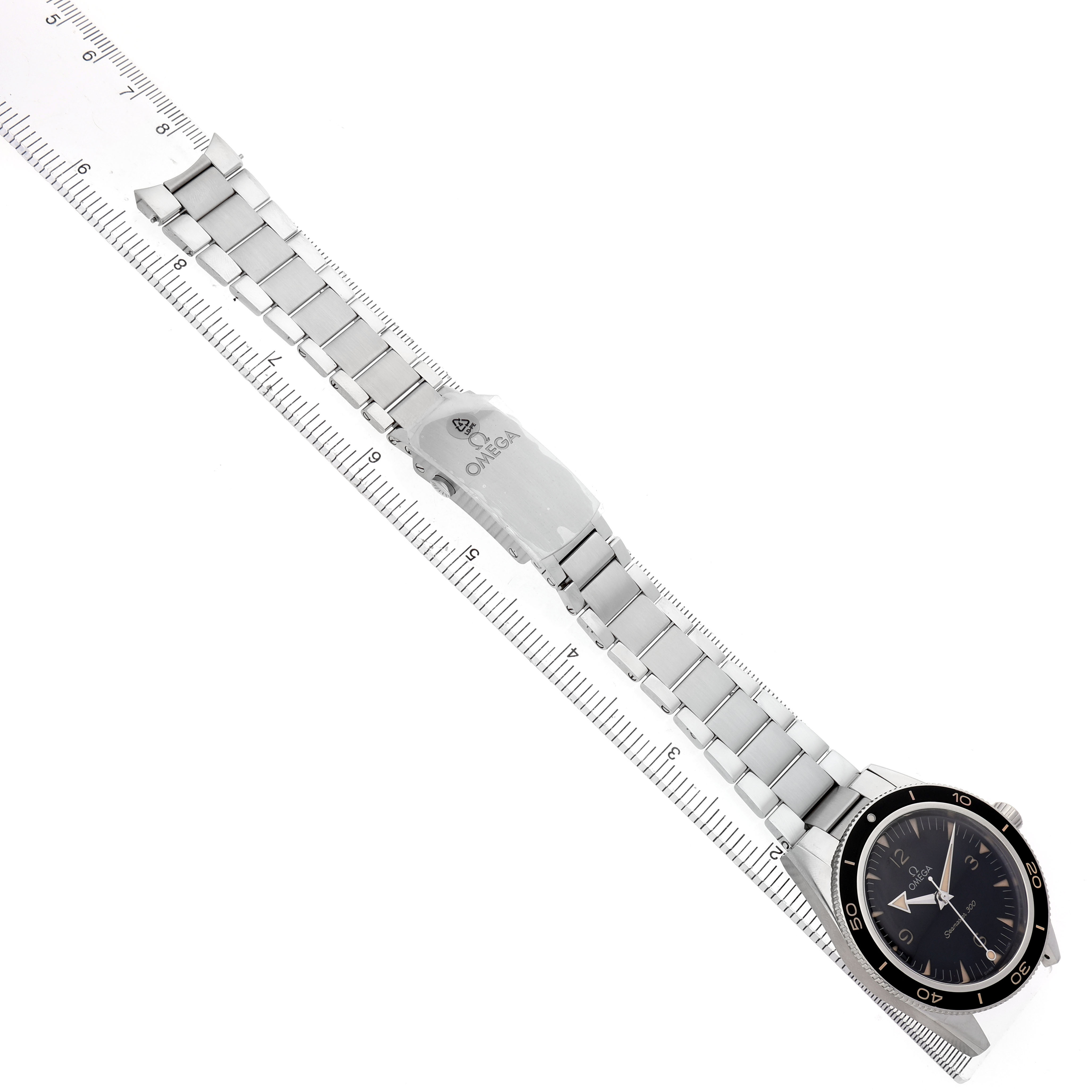 The Omega Seamaster 234.30.41.21.01.001 Men's Stainless Steel Black Dial watch is shown from a top-down angle, featuring the watch face and metal bracelet with clasp details aligned with a ruler.
