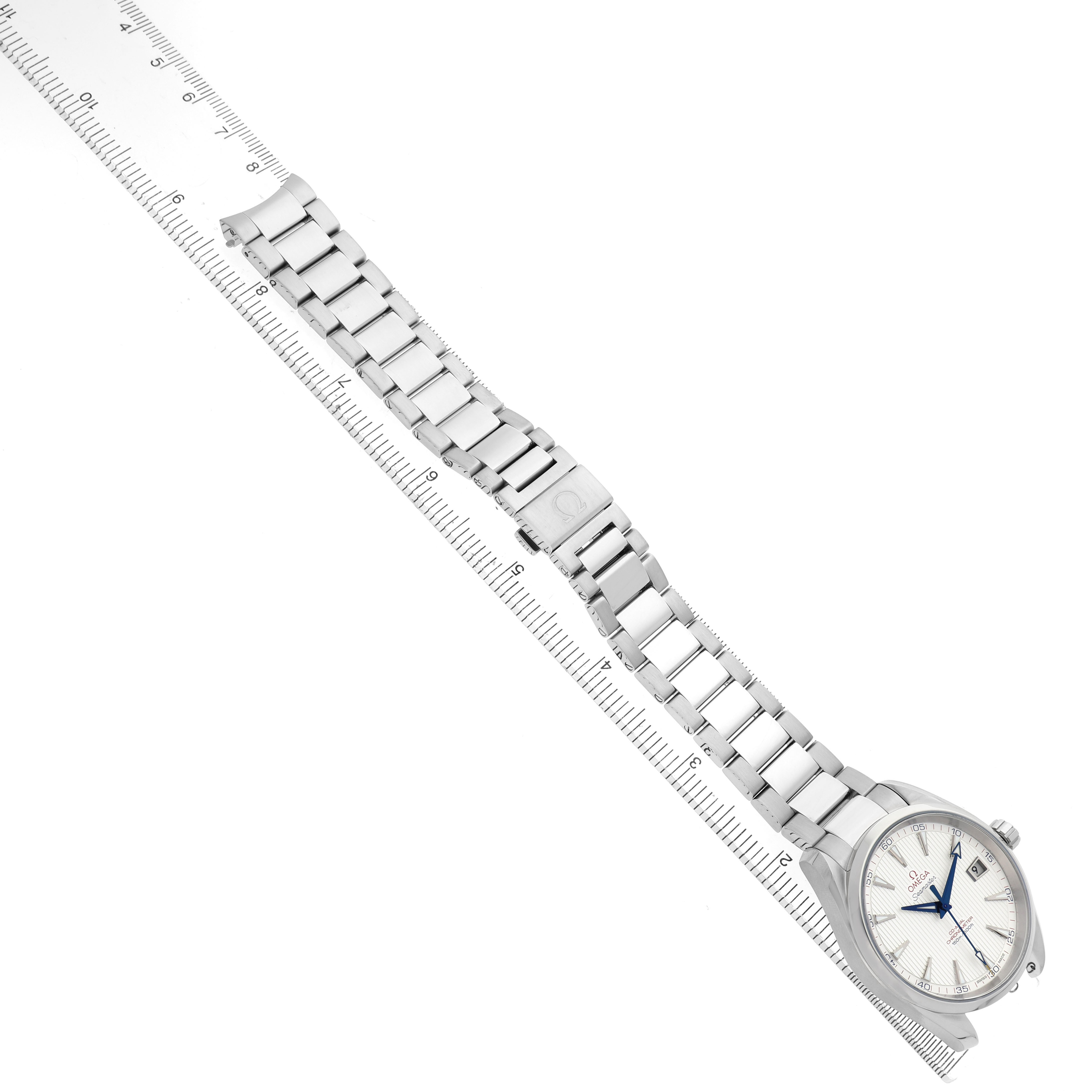 The Omega Aqua Terra 231.10.42.21.02.002 Men's Stainless Steel Silver Dial watch is shown from a top-down angle, displaying its face, bracelet, and clasp alongside a ruler for scale.
