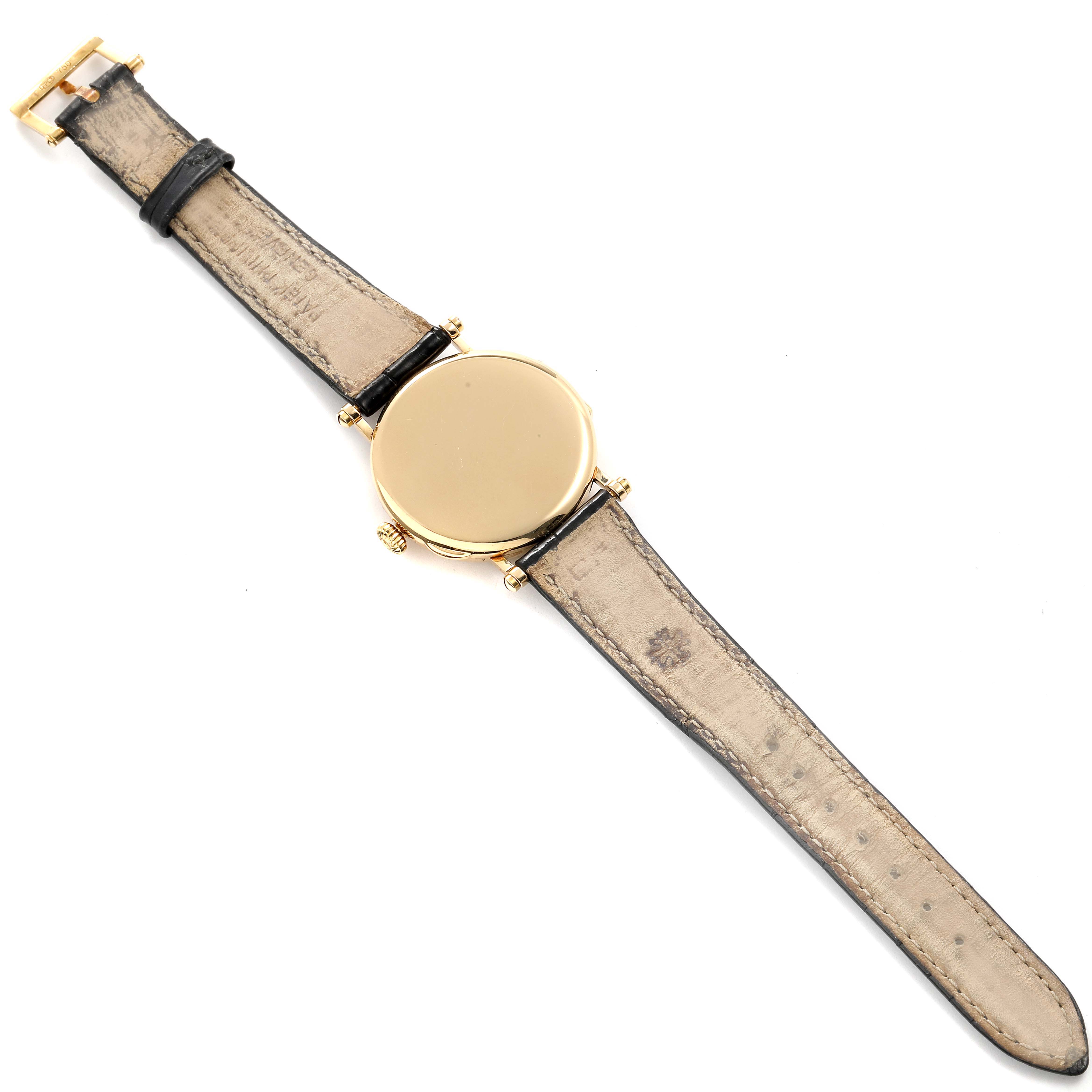 This image shows the back view of a Patek Philippe Calatrava 3960J Men's Yellow Gold White Dial 3960J Men's Yellow Gold White Dial watch, displaying the strap and gold case back.