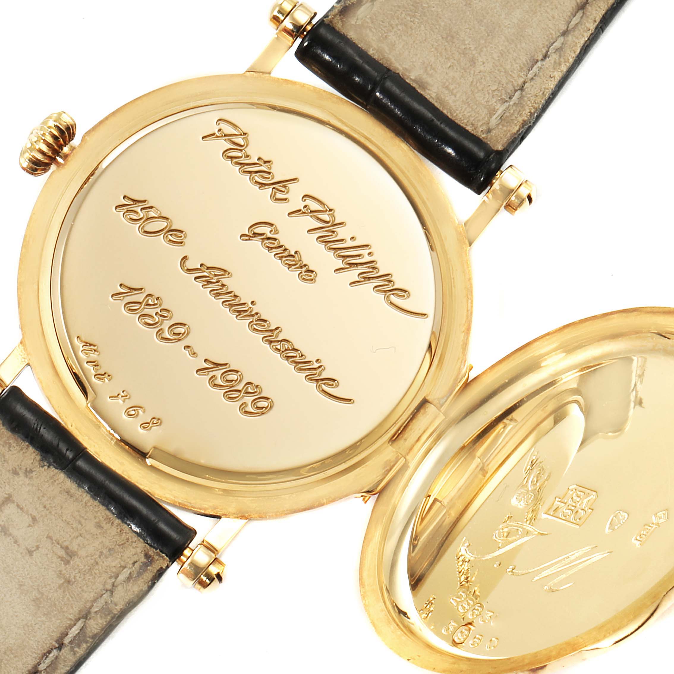 This image shows the case back and the inner engraving of the Patek Philippe Calatrava 3960J Men's Yellow Gold White Dial 3960J Men's Yellow Gold White Dial watch with the 150th-anniversary inscription.