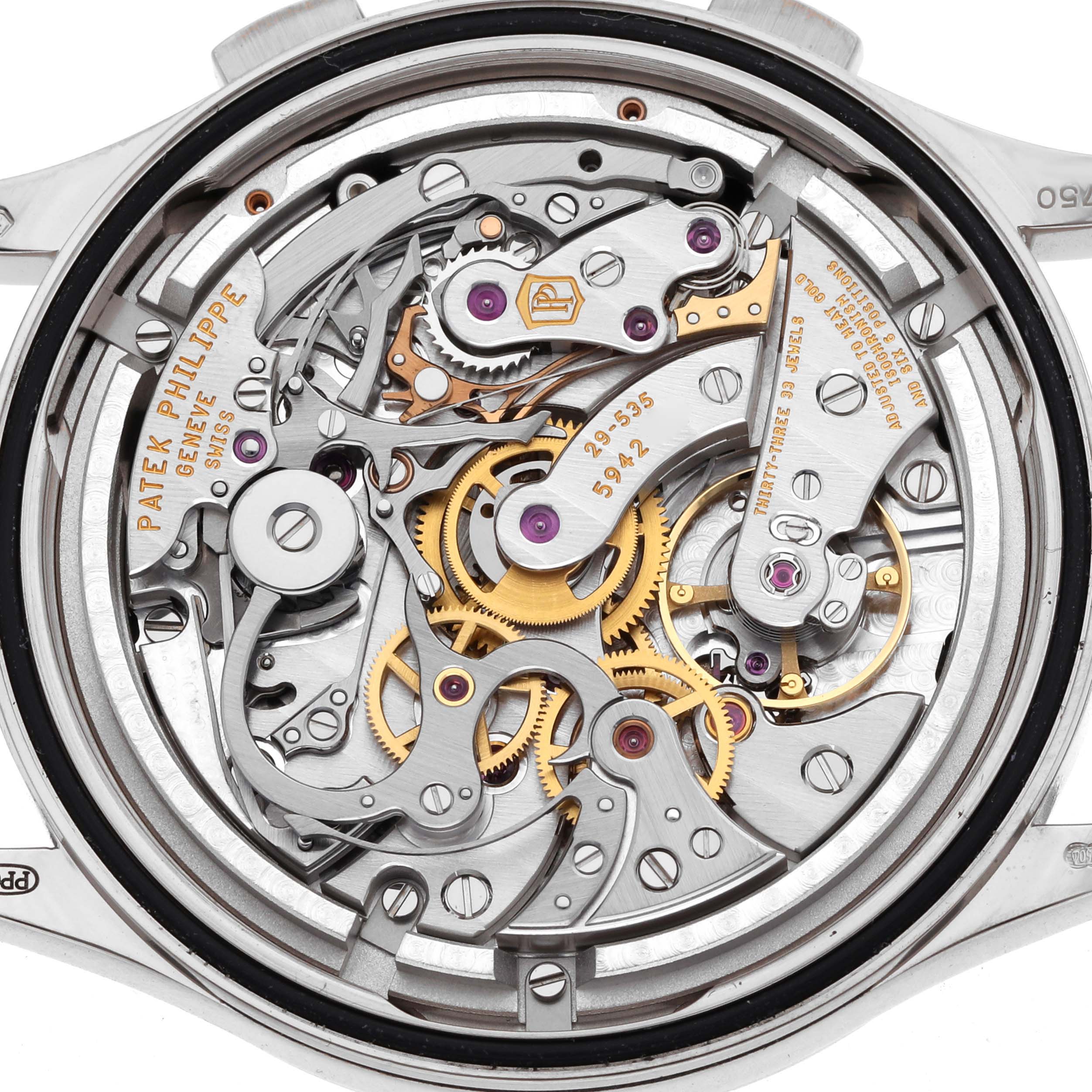 The image shows the intricate back view of a Patek Philippe Complications 5170G Men
s White Gold Black Dial watch, revealing its mechanical movement and gears.