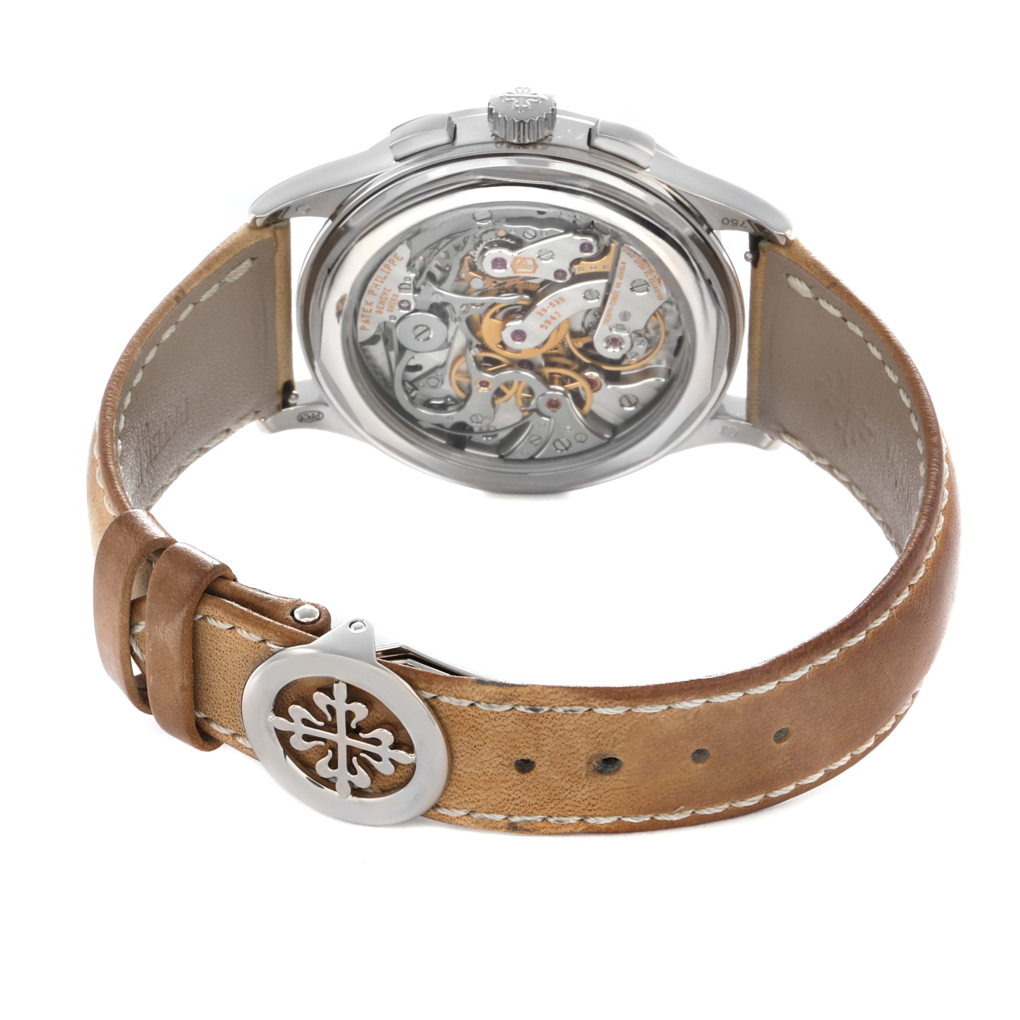 The image shows a Patek Philippe Complications 5170G Men
s White Gold Black Dial watch from the back, highlighting its intricate movement and leather strap.