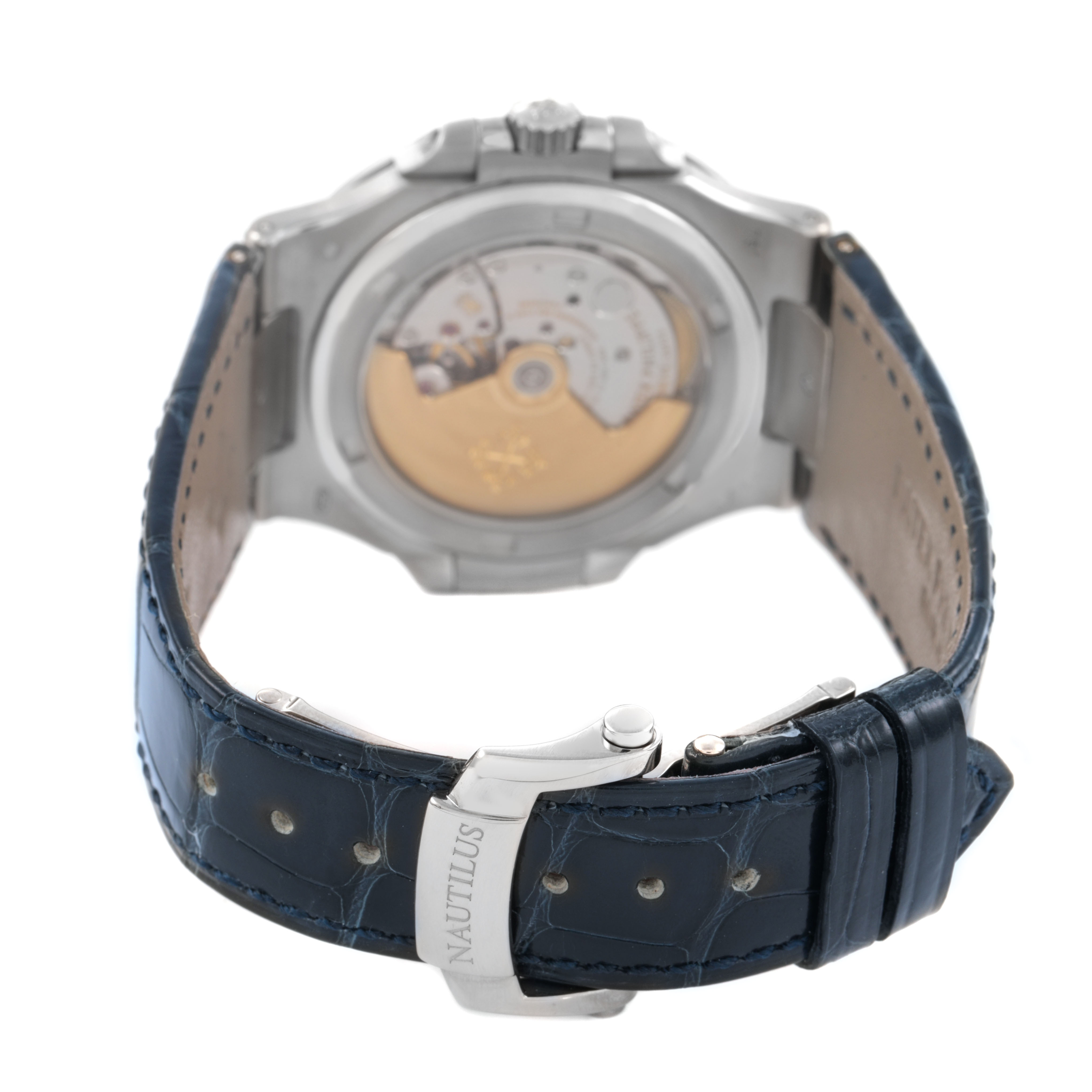 The image shows the back of a Patek Philippe Nautilus 5711G-001 Men's White Gold Silver Dial watch, highlighting the movement and a leather strap with a clasp.