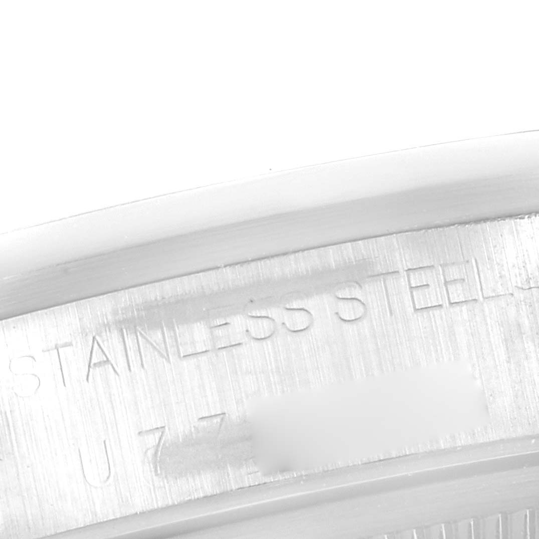 This image shows a close-up of the case back edge of a Rolex Air-King 14000 Men's Stainless Steel Black Dial 14000 Men's Stainless Steel Black Dial watch, with "STAINLESS STEEL" inscribed.