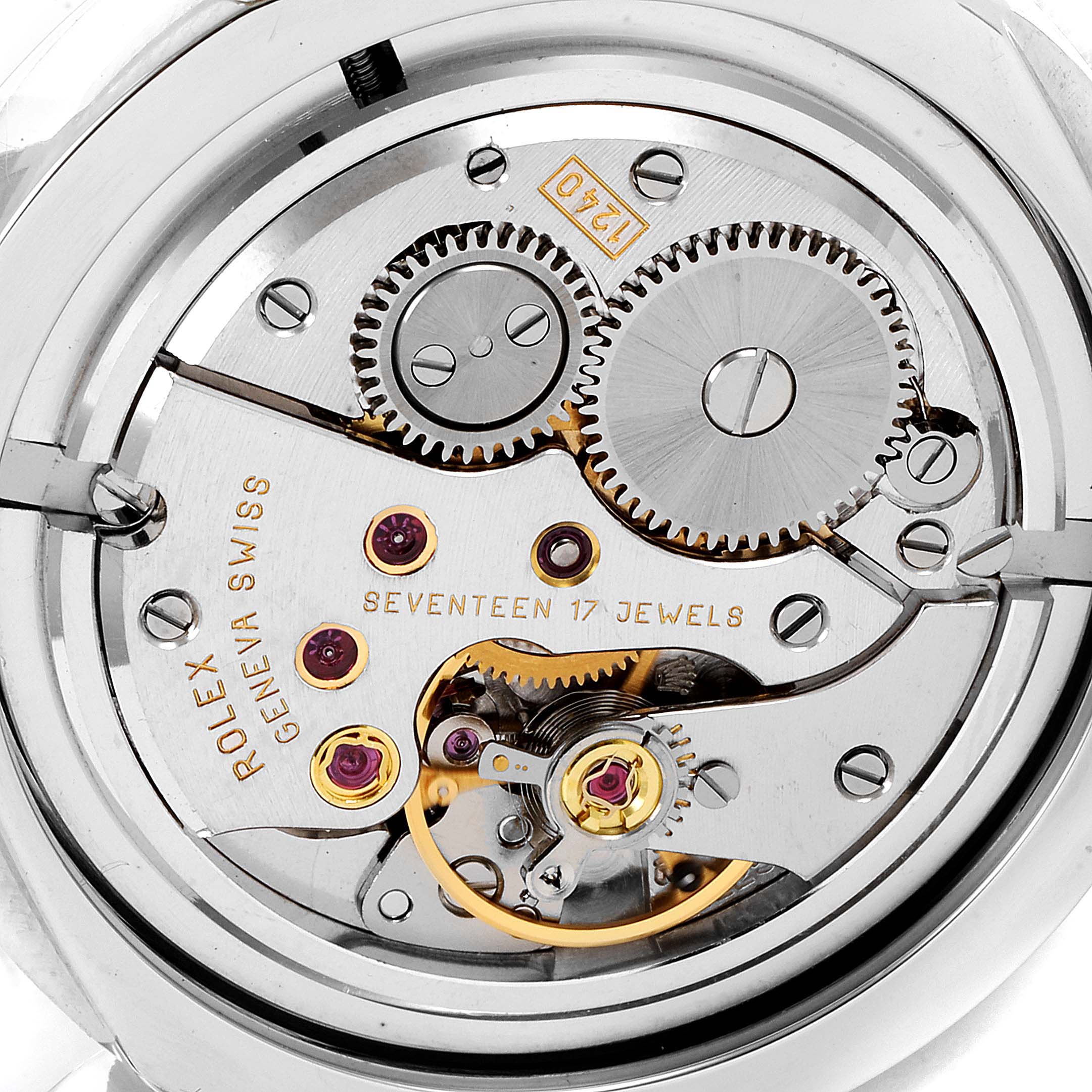 The image shows the intricate internal mechanism, including gears and jewels, of a Rolex Cellini 5240 Men
s Platinum Mother of Pearl Dial 5240 Men
s Platinum Mother of Pearl Dial watch.