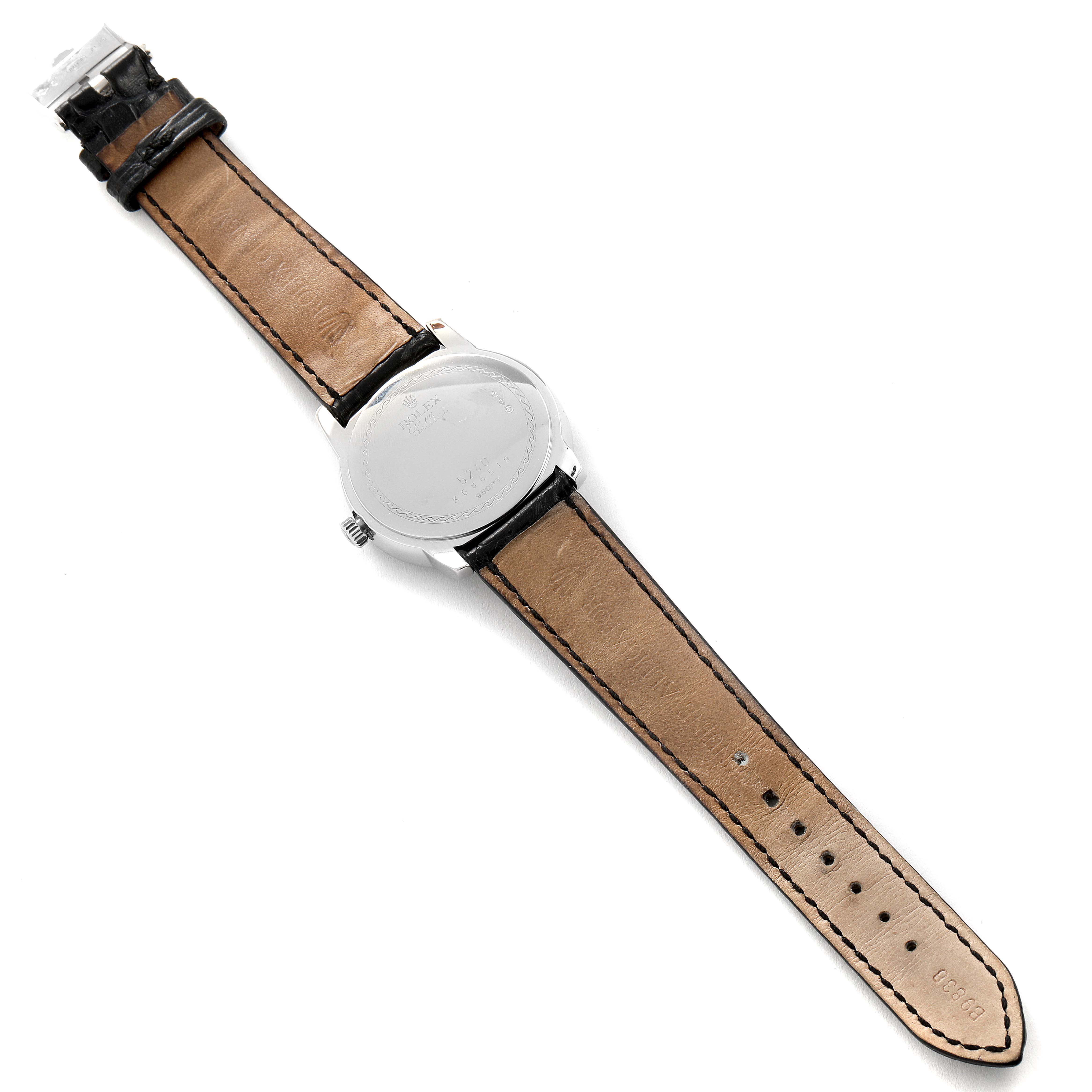 The image shows the back view of a Rolex Cellini 5240 Men
s Platinum Mother of Pearl Dial 5240 Men
s Platinum Mother of Pearl Dial watch, highlighting its leather strap and case back.