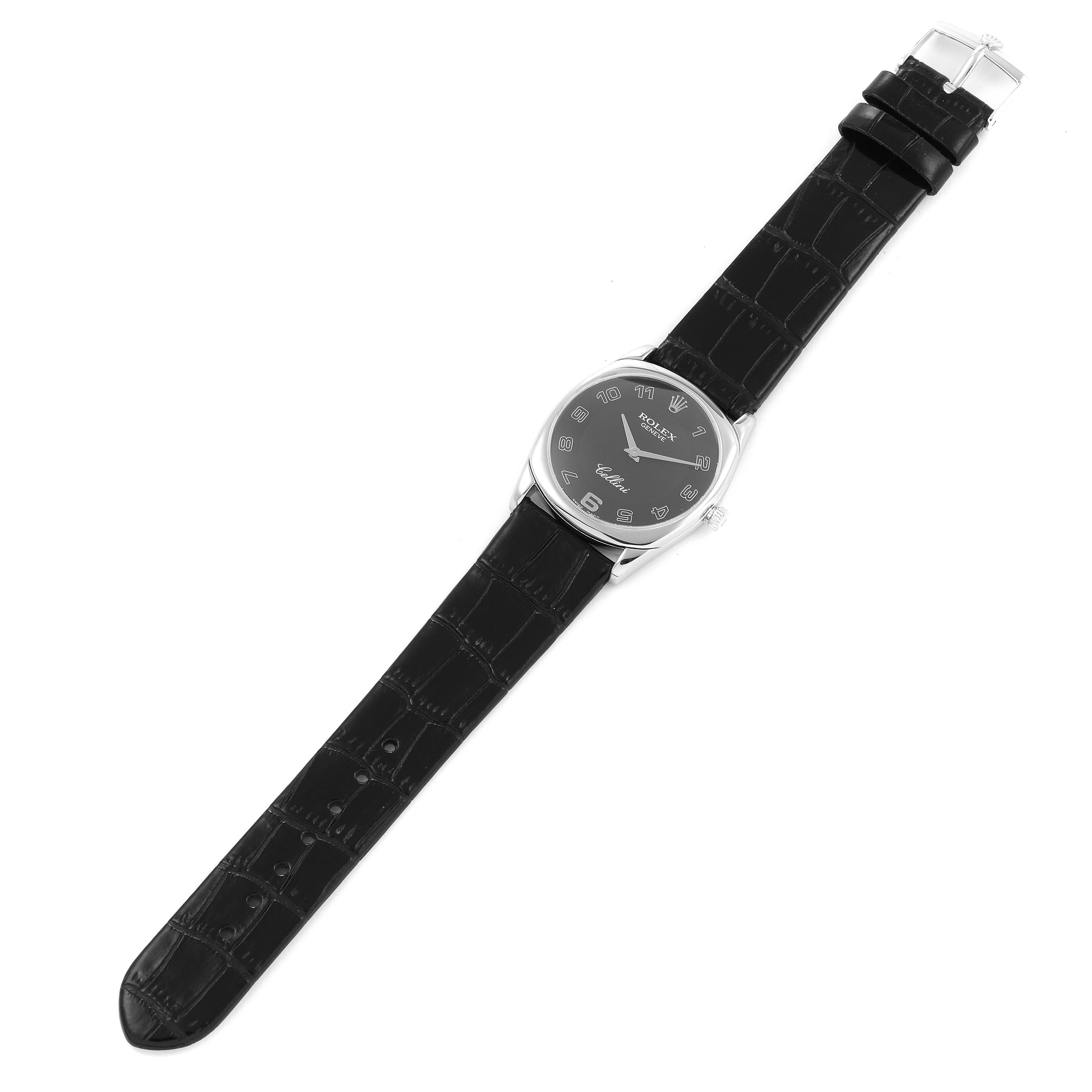 The Rolex Cellini 4233 Men
s White Gold Black Dial 4233 Men
s White Gold Black Dial watch is shown from a top-down angle, displaying the face, case, and leather strap with a deployed buckle.