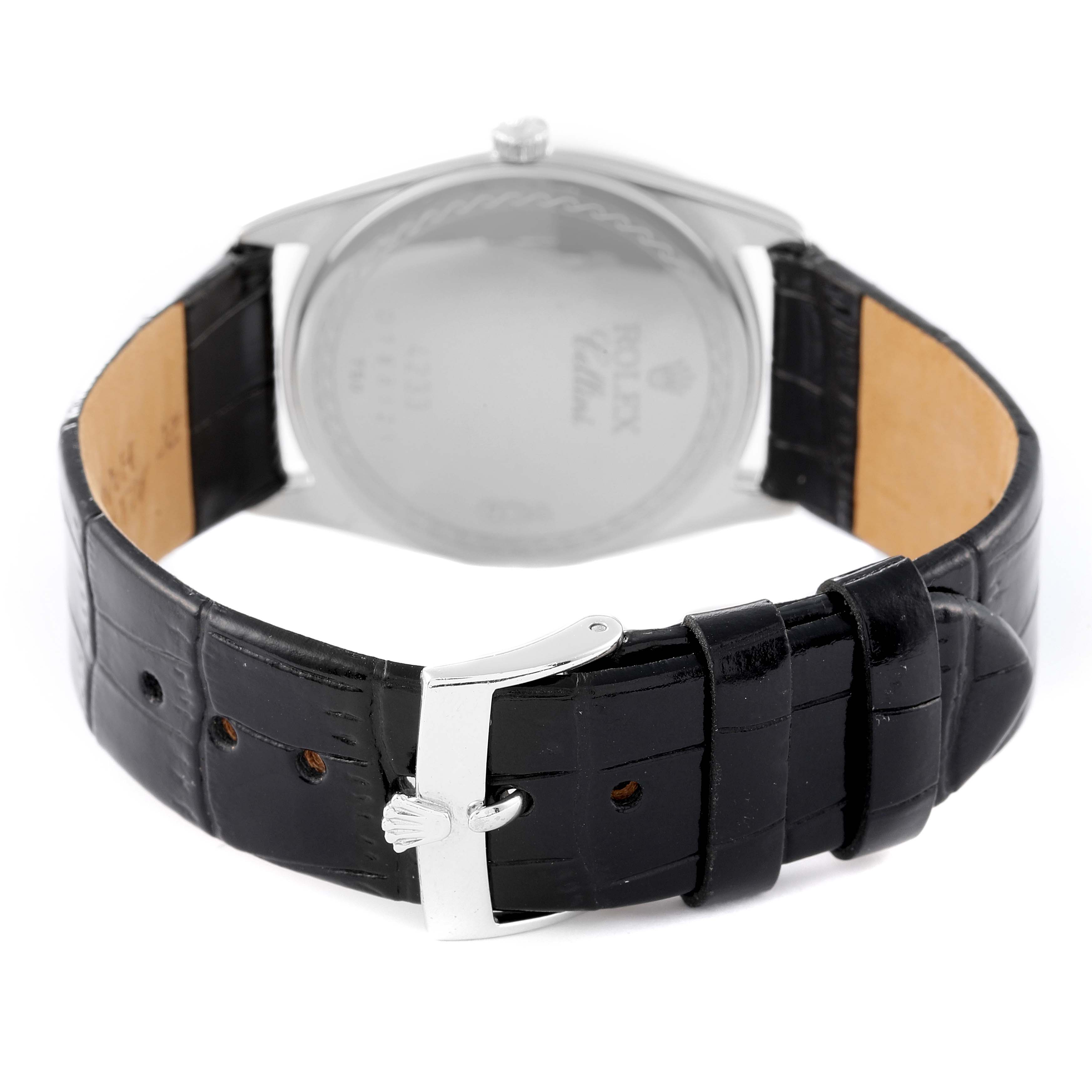 The image shows the back view of a Rolex Cellini 4233 Men
s White Gold Black Dial 4233 Men
s White Gold Black Dial model watch, highlighting its leather strap and clasp.