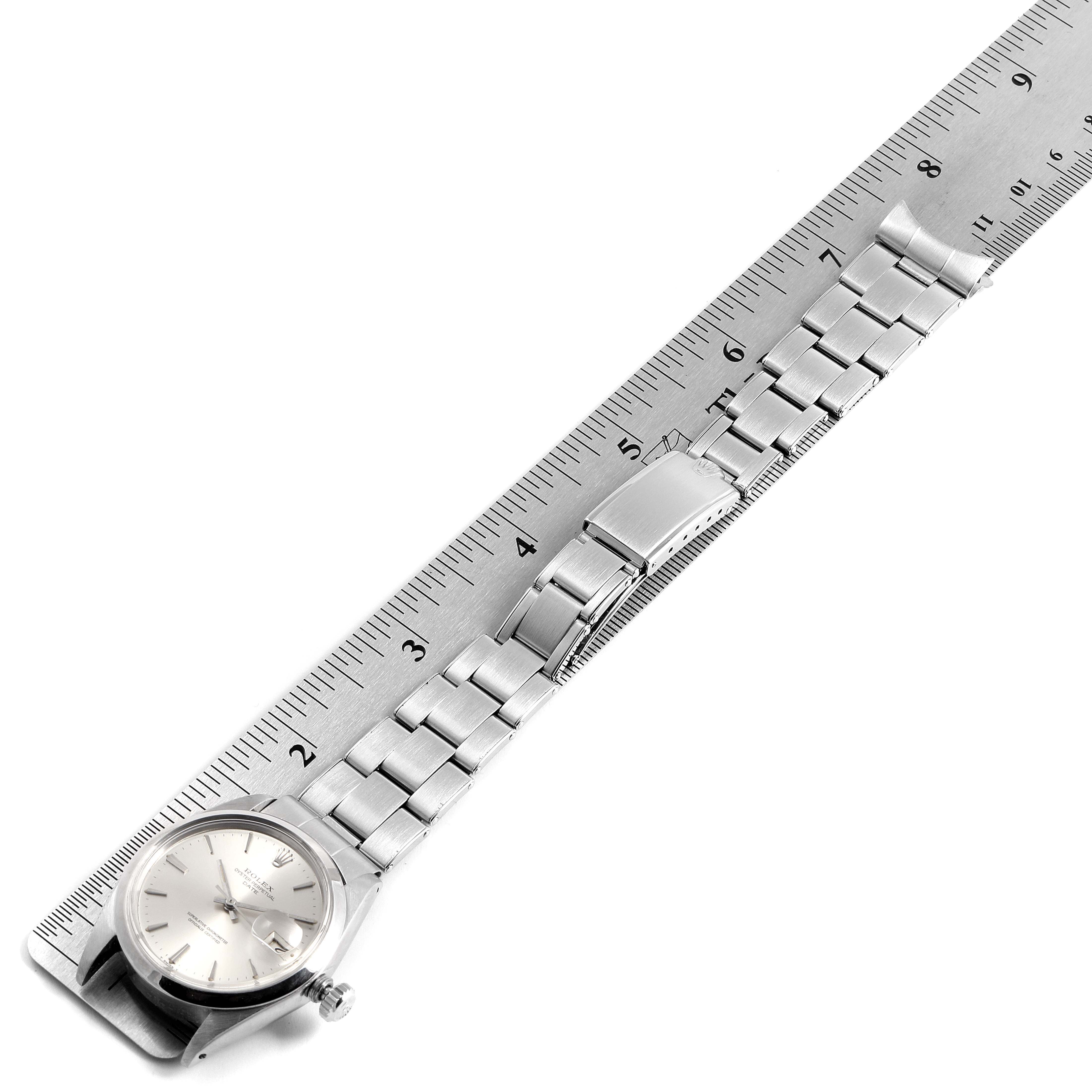 The image shows a Rolex Vintage Collection 1500 Men's Stainless Steel Silver Dial 1500 Men's Stainless Steel Silver Dial watch laid flat next to a ruler, displaying the face, bracelet, and clasp.