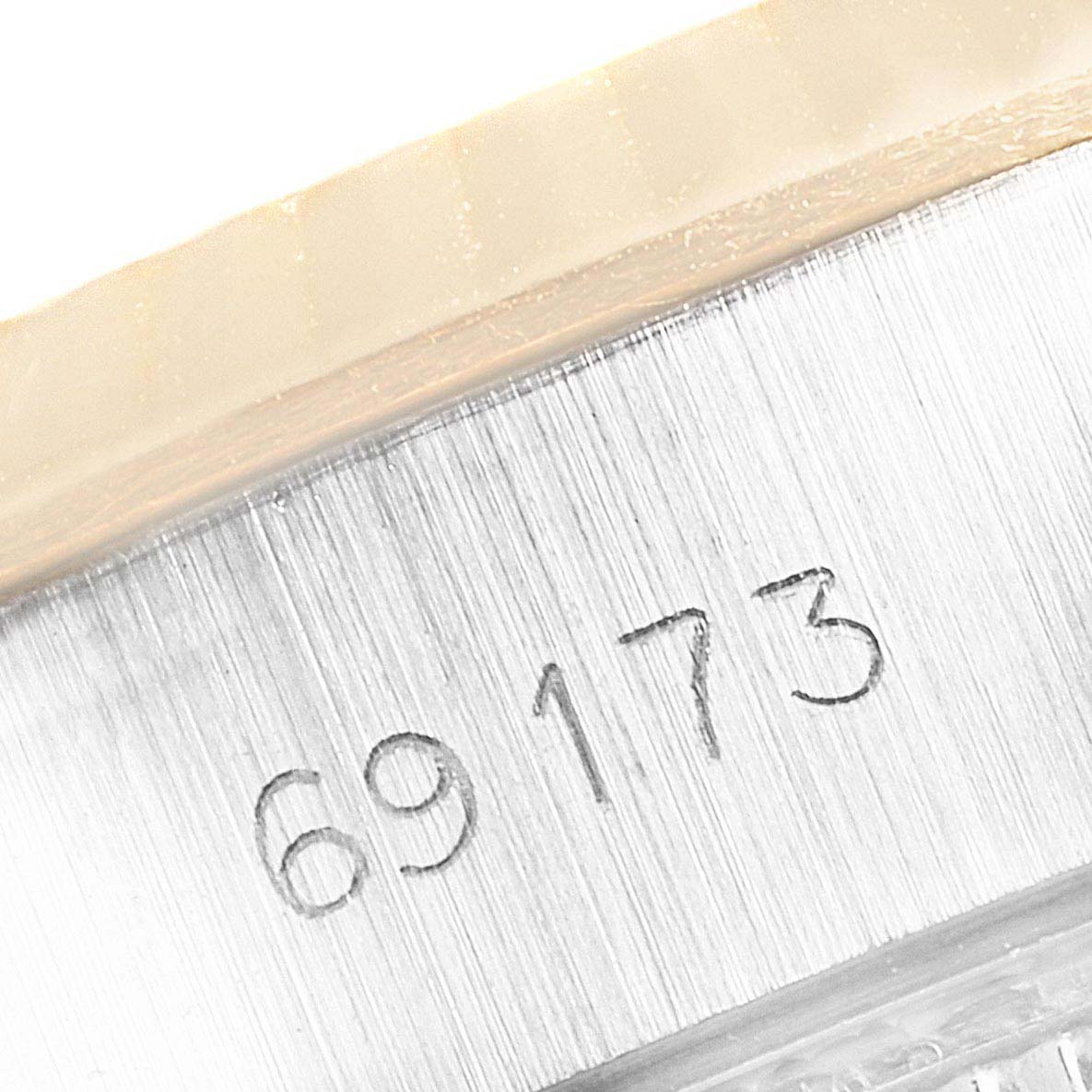 This close-up image shows part of the casing with the engraved serial number "69173" on a Rolex Datejust 69173 Women's Steel and Gold (two tone) Champagne Dial 69173 Women's Steel and Gold (two tone) Champagne Dial watch.