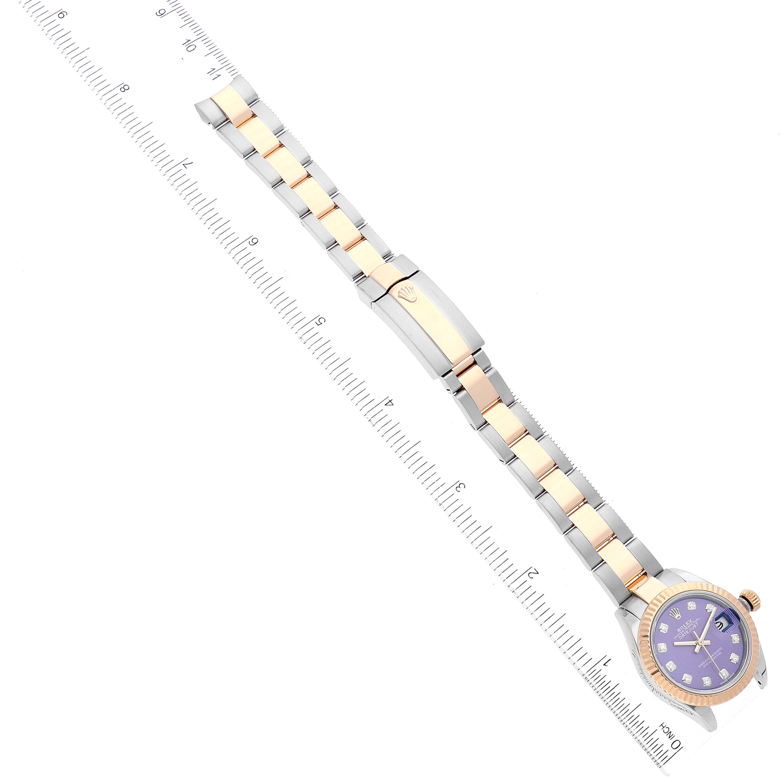 The image shows a Rolex Datejust 279173 Women's Stainless Steel Purple Dial 279173 Women's Stainless Steel Purple Dial watch laid flat with its bracelet aligned alongside a ruler for measurement.