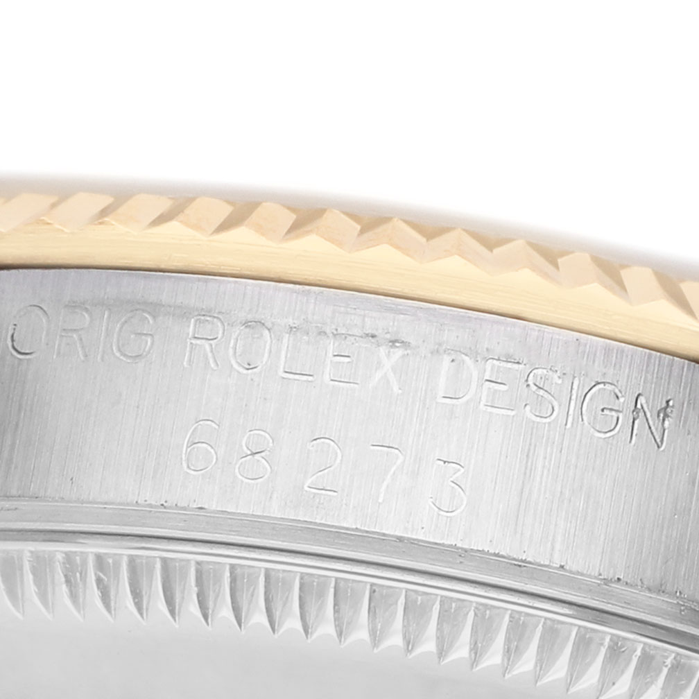 The image shows a close-up of the bezel and engraved serial number on the side of a Rolex Datejust 68273 Women's Steel and Gold (two tone) Beige Dial watch.