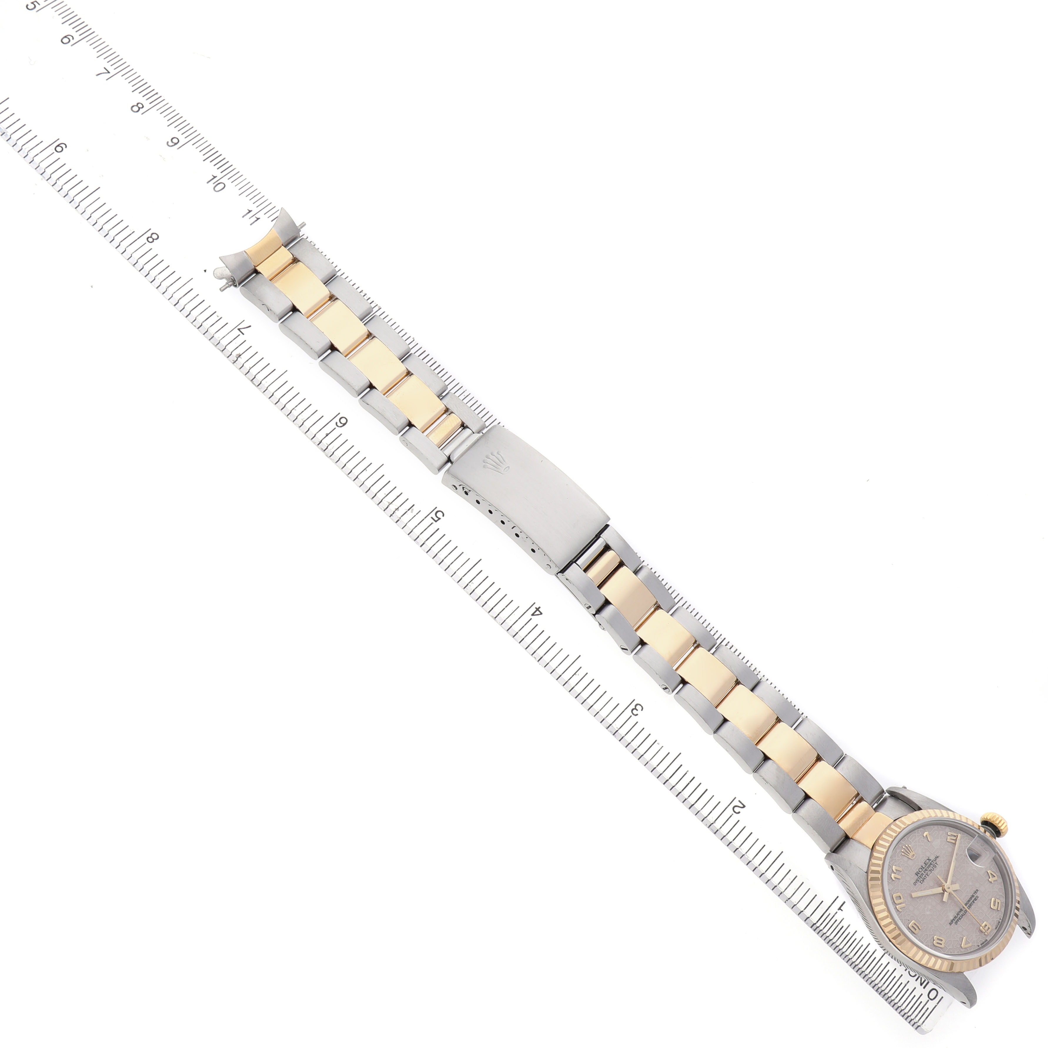 The image shows a Rolex Datejust 68273 Women's Steel and Gold (two tone) Beige Dial watch at a top-down angle, featuring the bracelet, clasp, and part of the dial against a ruler.
