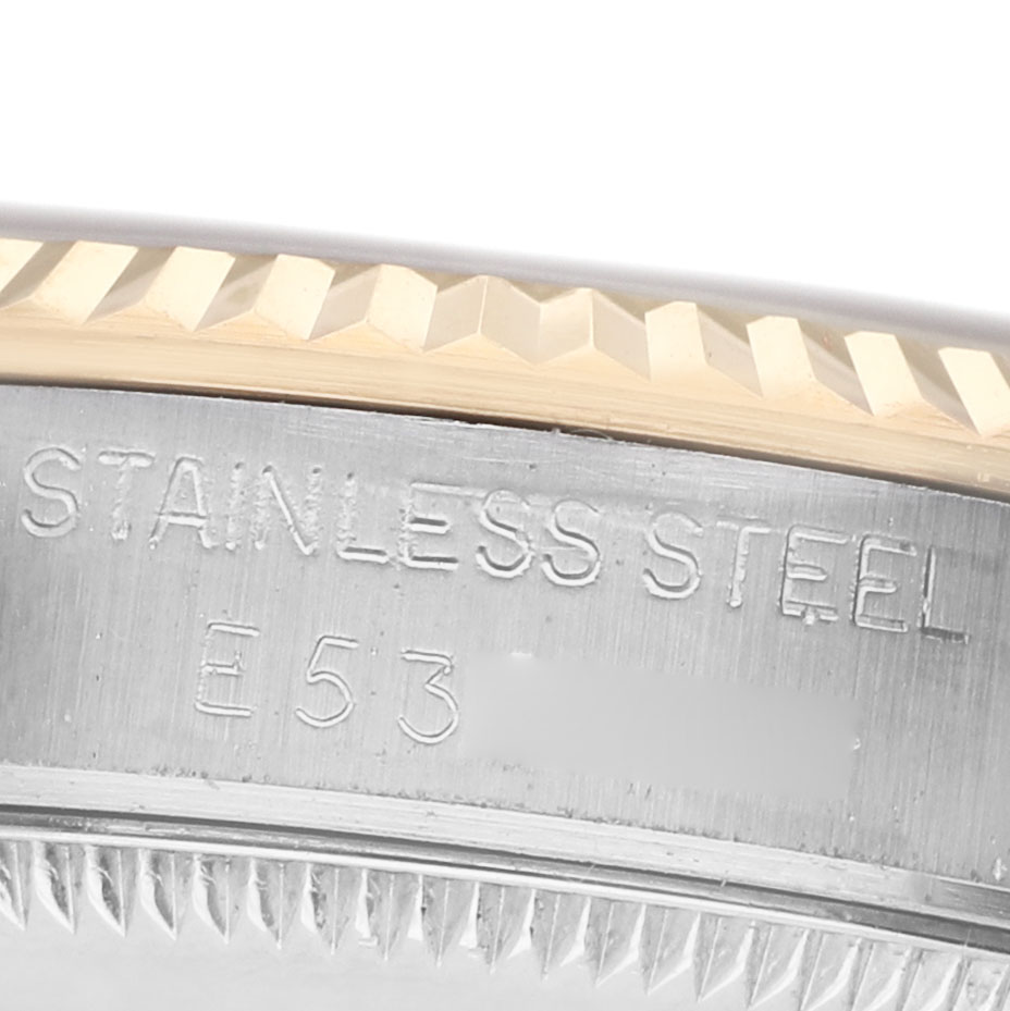 The image shows a close-up of the Rolex Datejust 68273 Women's Steel and Gold (two tone) Beige Dial edge, focusing on the stainless steel part with engraved text and fluted bezel.