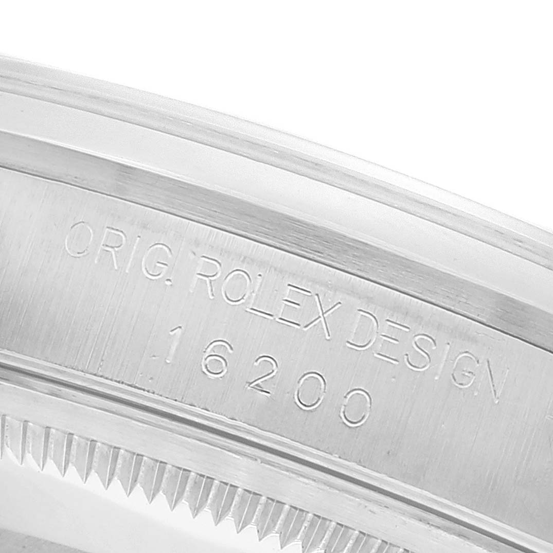 This image shows a detailed close-up of the Rolex Datejust 16200 Men's Stainless Steel Silver Dial 16200 Men's Stainless Steel Silver Dial model's inner bezel, displaying the inscription "ORIG. ROLEX DESIGN 16200."
