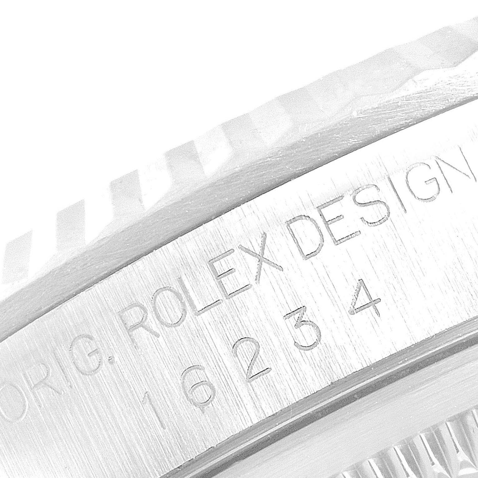 This image shows a close-up of the model number and "Rolex Design" engraving on the case of a Rolex Datejust 16234 Men's Stainless Steel Beige Dial 16234 Men's Stainless Steel Beige Dial watch.