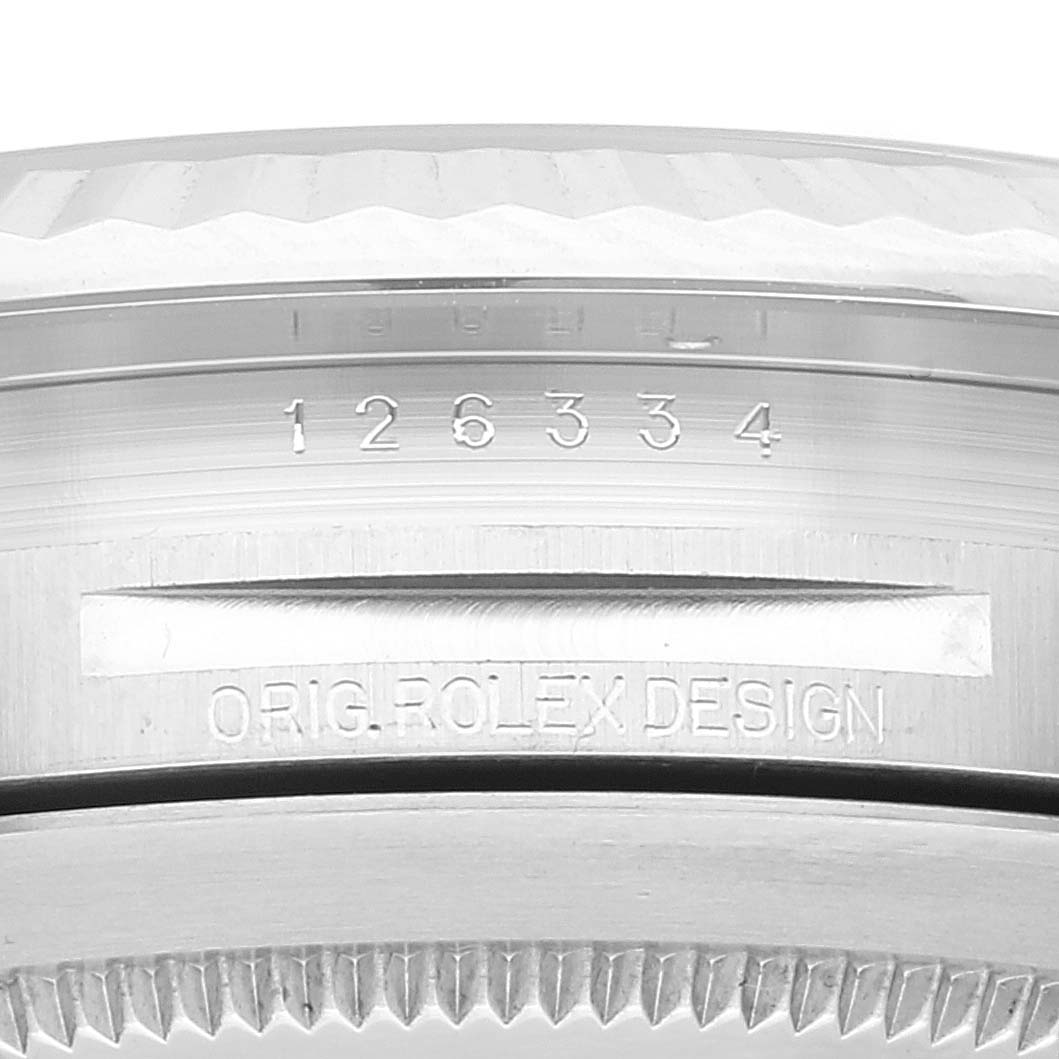 This close-up of the Rolex Datejust 41 126334 Men's Stainless Steel Silver Dial 126334 Men's Stainless Steel Silver Dial model shows engraved details on the case and the fluted edge of the bezel.