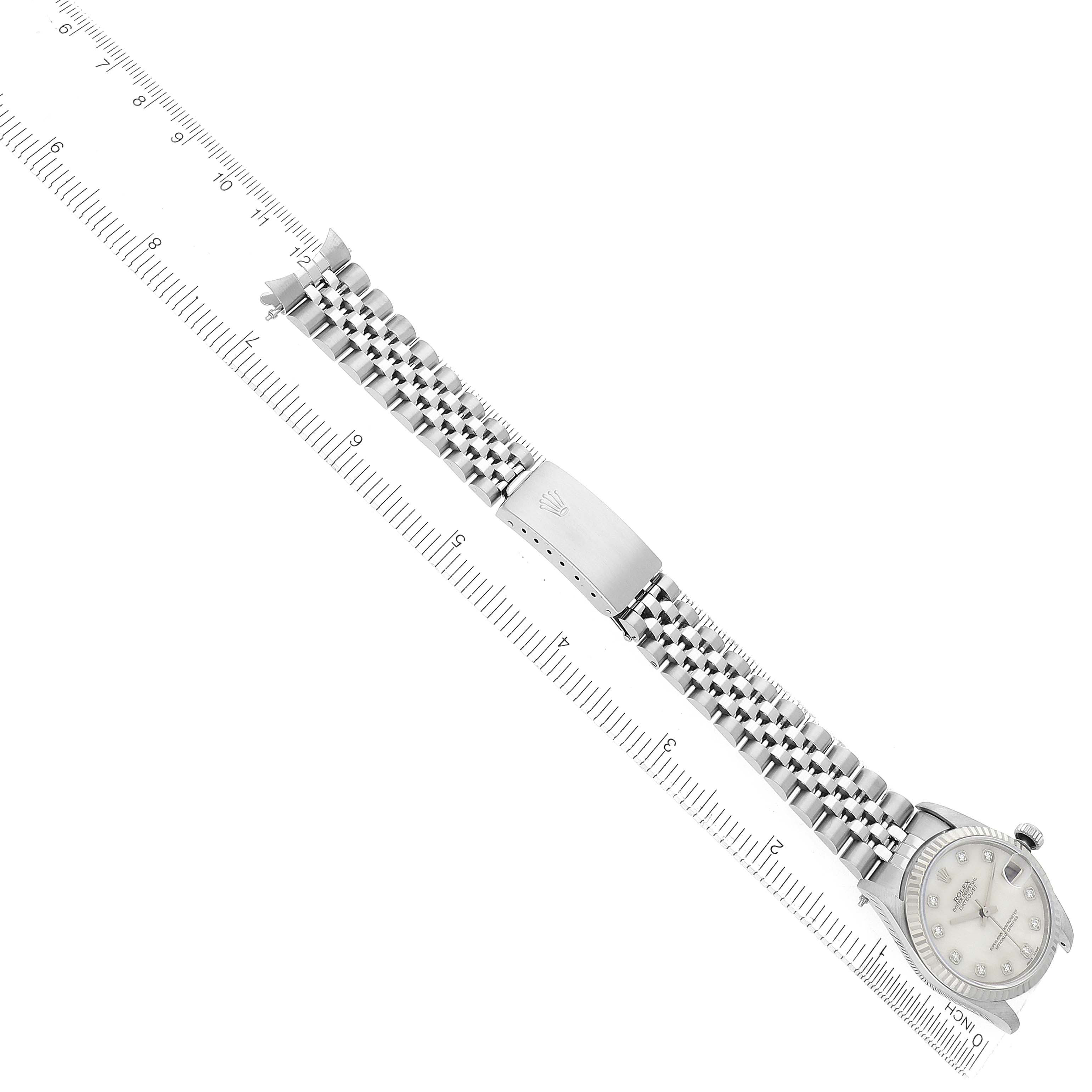The Rolex Mid-Size 68274 Women's Stainless Steel Mother of Pearl Dial watch is shown at an angle, displaying the bracelet, clasp, and part of the dial along with a measuring scale.