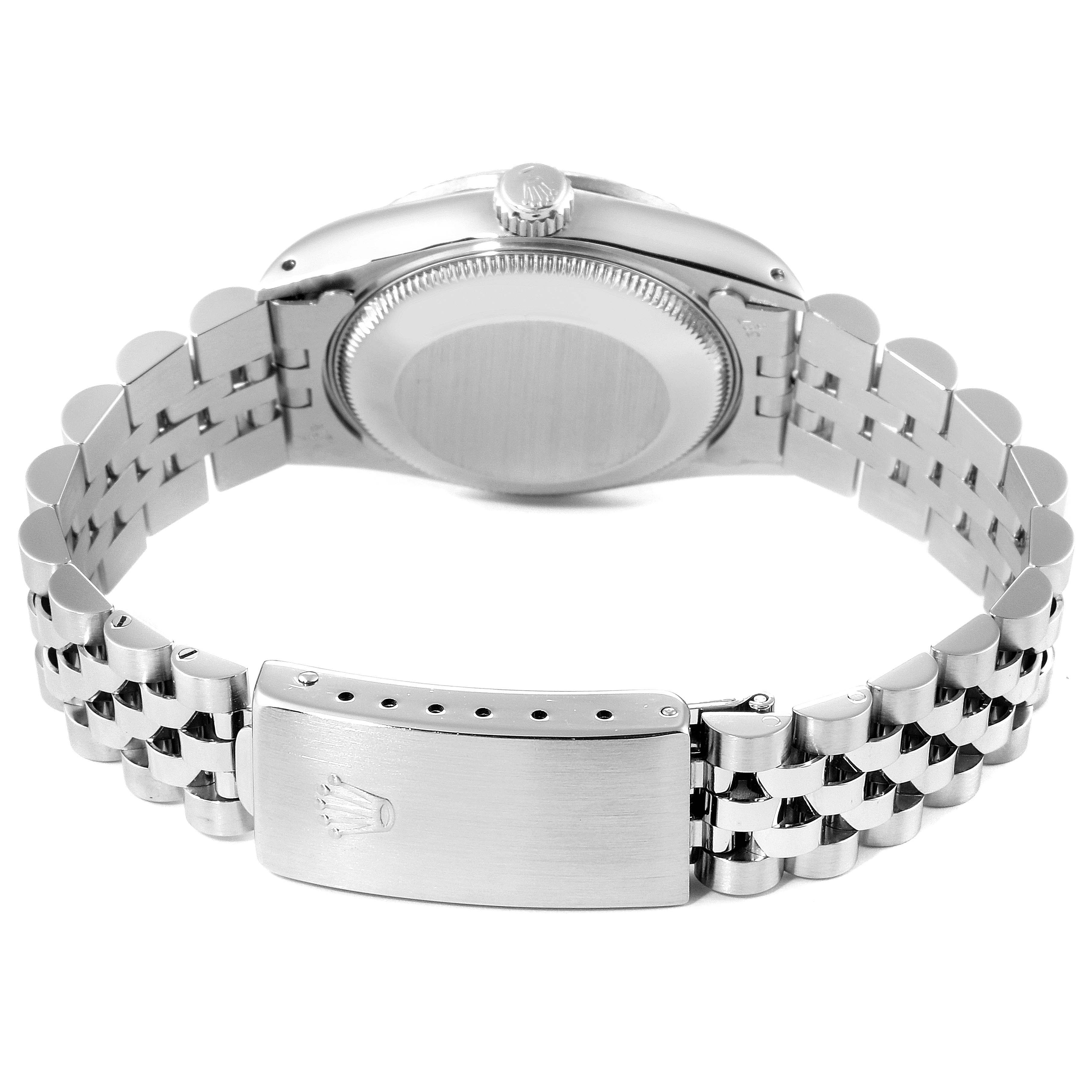 This image shows the back case, crown, and clasp of a Mid-Size Rolex watch with a silver bracelet.