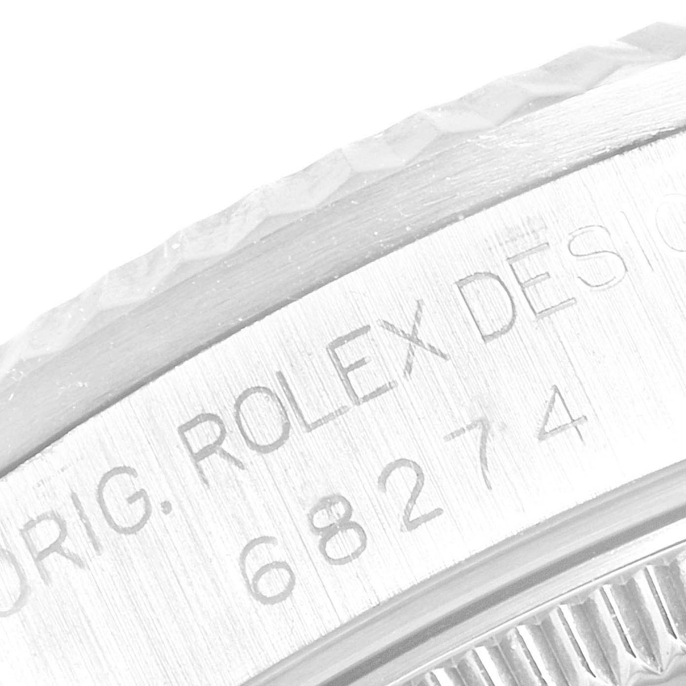 This close-up image of the Rolex Mid-Size 68274 Women's Stainless Steel Silver Dial 68274 Women's Stainless Steel Silver Dial model shows the engraved bezel and part of the model number on the side.