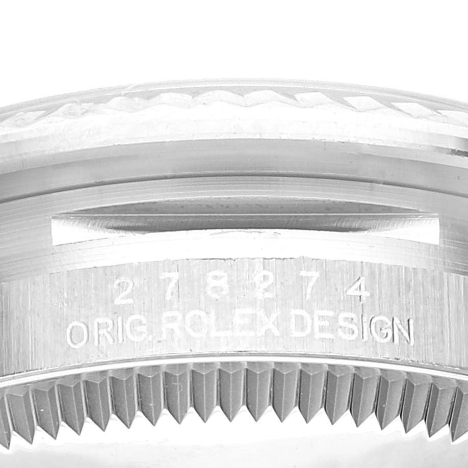 This image shows a close-up of the case back and side engravings of a Rolex Mid-Size 278274 Women's Stainless Steel Grey Dial 278274 Women's Stainless Steel Grey Dial model watch, featuring the serial number and "Orig Rolex Design."