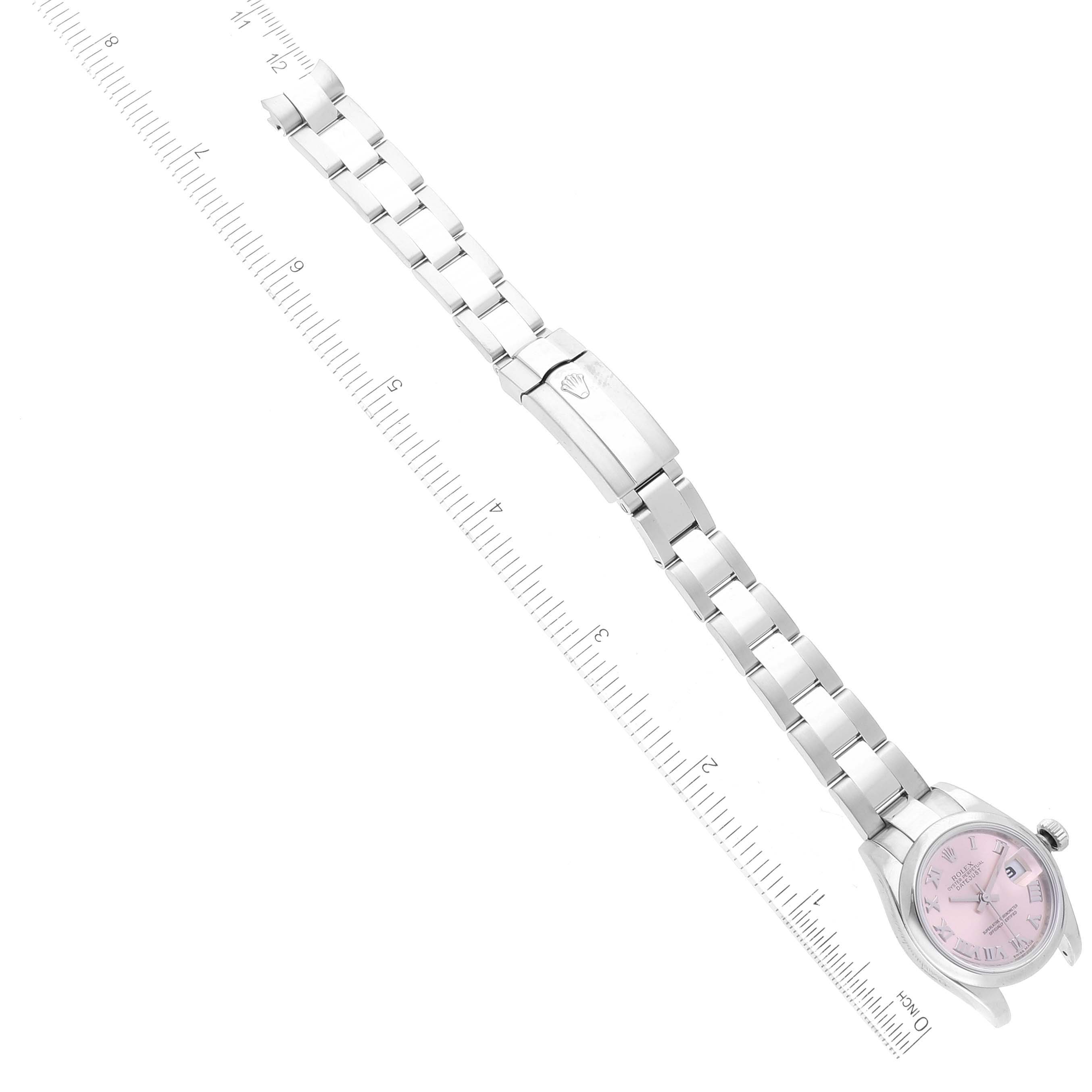 The image shows a Rolex Datejust 179160 Women's Stainless Steel Pink Dial 179160 Women's Stainless Steel Pink Dial watch laid flat with its pink dial and full bracelet visible, next to a ruler for scale.