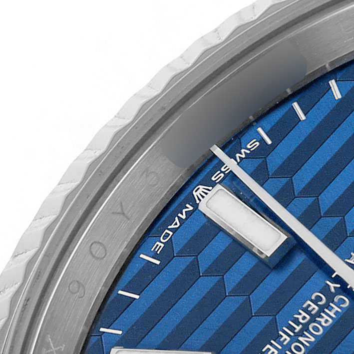 The image shows a close-up of the Rolex Datejust 126234 Men's Stainless Steel Blue Dial model's bezel and part of the patterned blue dial.