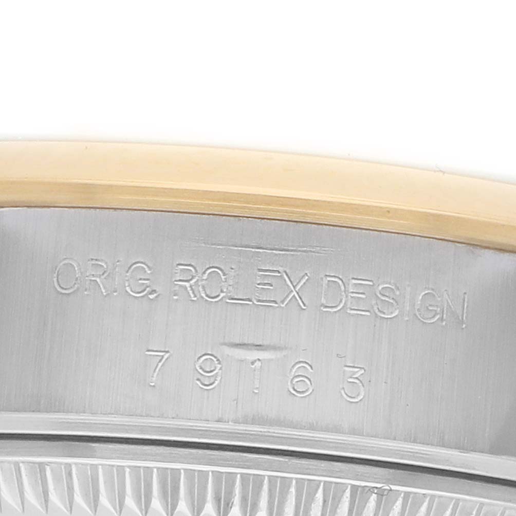 The image shows a close-up of the side engraving on a Rolex Datejust 79163 Women
s Steel and Gold (two tone) Silver Dial watch, displaying the serial number and "ORIG. ROLEX DESIGN."