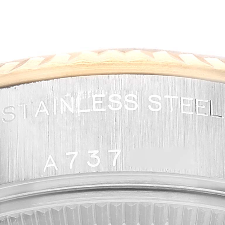 This image shows an angled close-up of the stainless steel back and part of the fluted bezel of a Rolex Datejust 79173 Women's Steel and Gold (two tone) Champagne Dial 79173 Women's Steel and Gold (two tone) Champagne Dial watch.